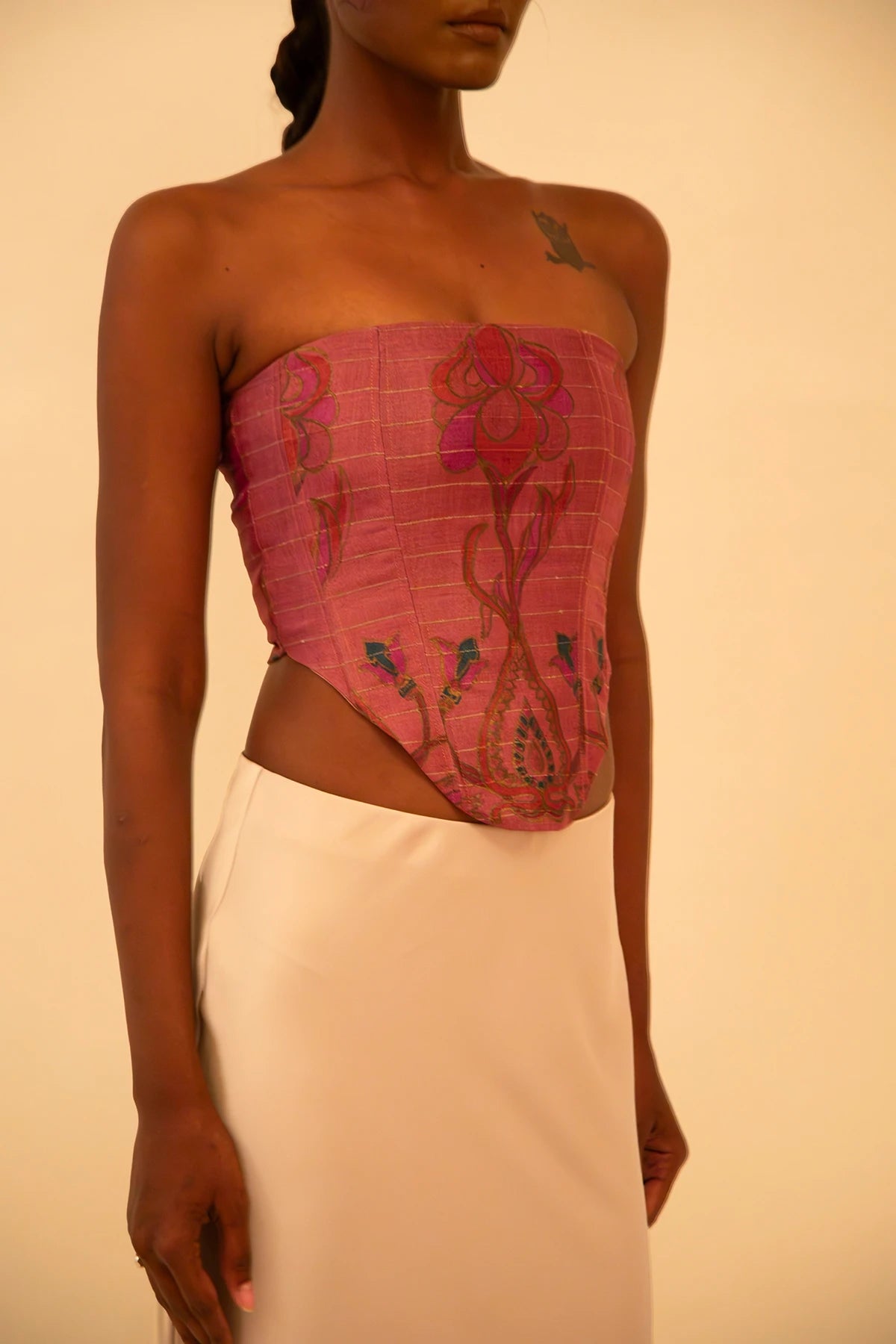 Handcrafted strapless corset made from upcycled vintage silk sari, a structured silhouette, celebrating artisanal craftsmanship and conscious design.