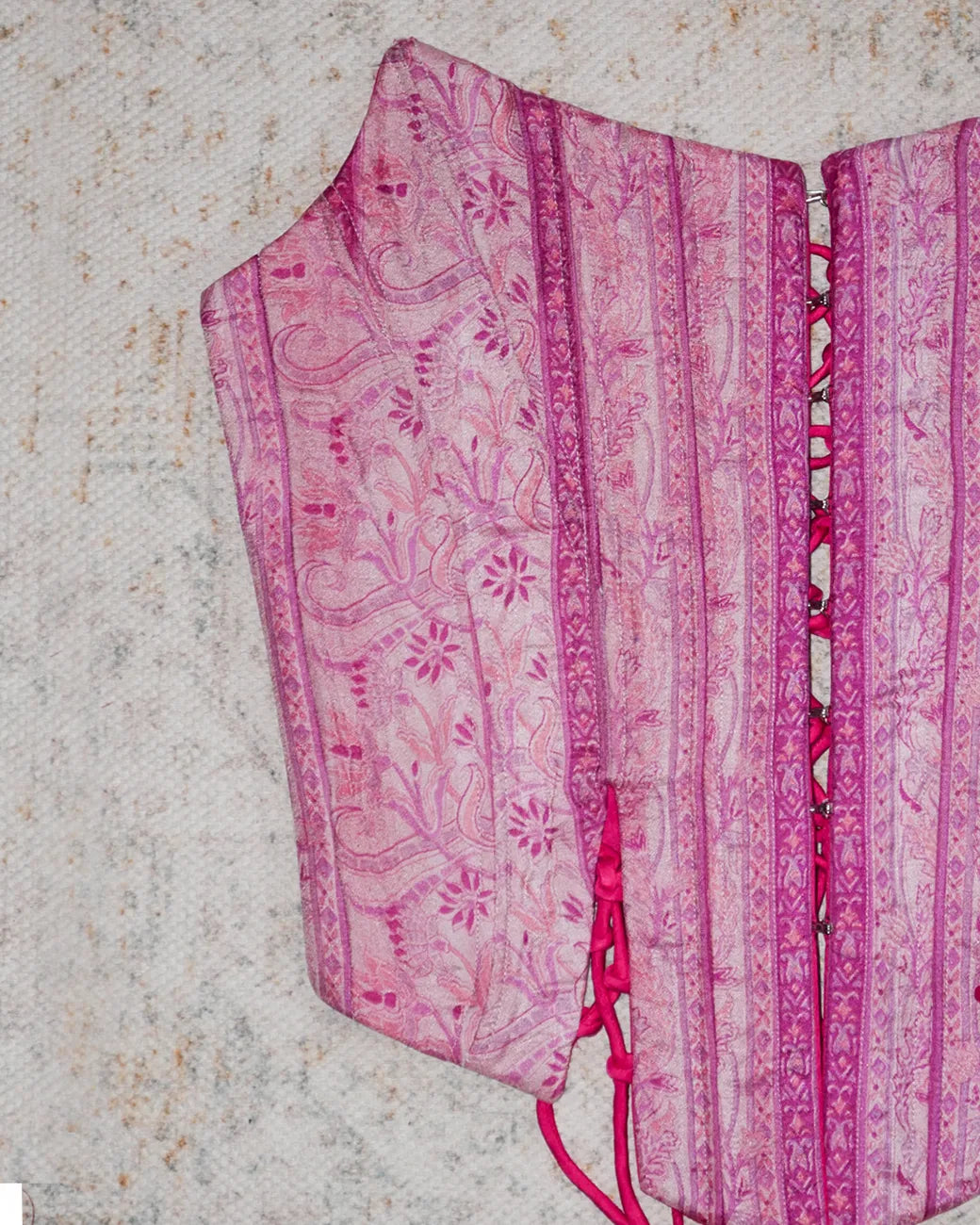 four-panel corset crafted from a vintage pink silk sari, featuring V-cut detailing and adjustable lace-up panels, consciously handcrafted by Bodements to celebrate heritage, craft, and mindful fashion.
