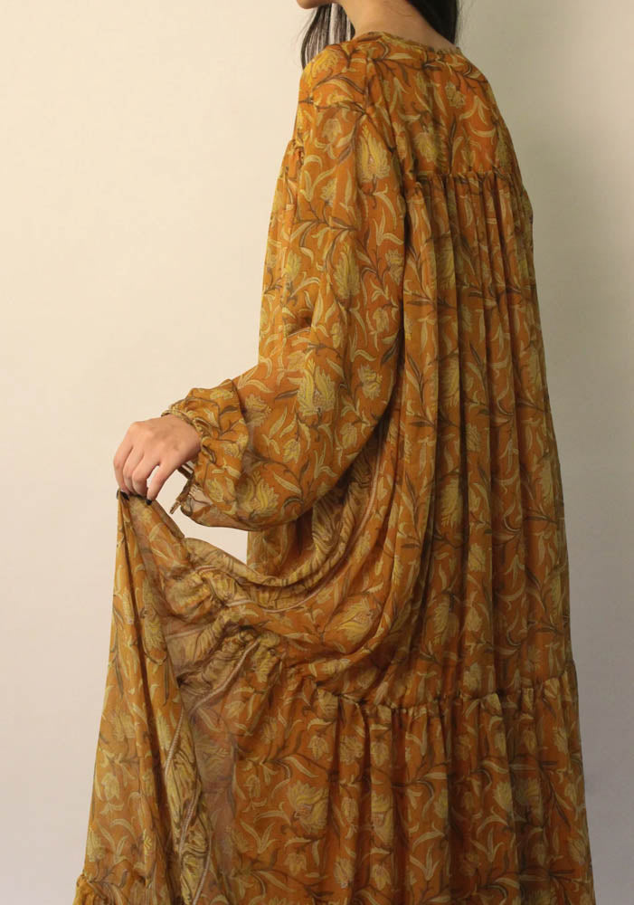 SAIA vintage silk maxi dress in black with beige floral motifs, flowy silhouette, versatile deep V or tied neckline, and elastic cuff long sleeves.