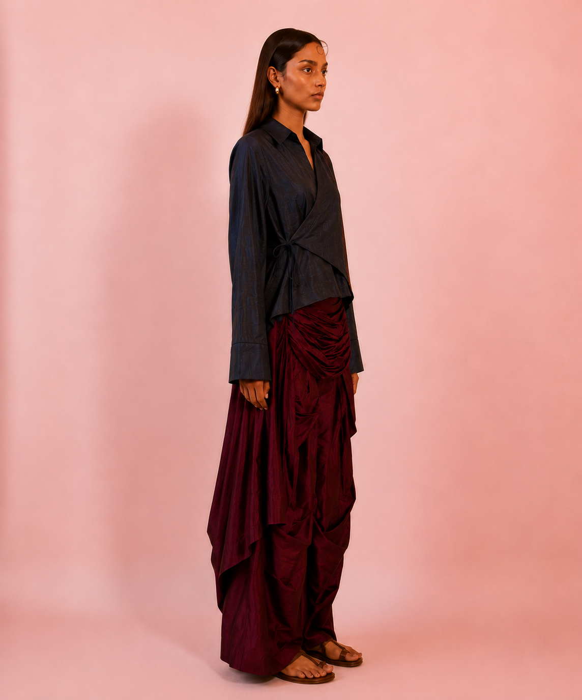 VASTRAM is our one-of-a-kind loose-fitting outer tunic, handcrafted in-house with a layered, asymmetrical fall and patched full sleeves.
