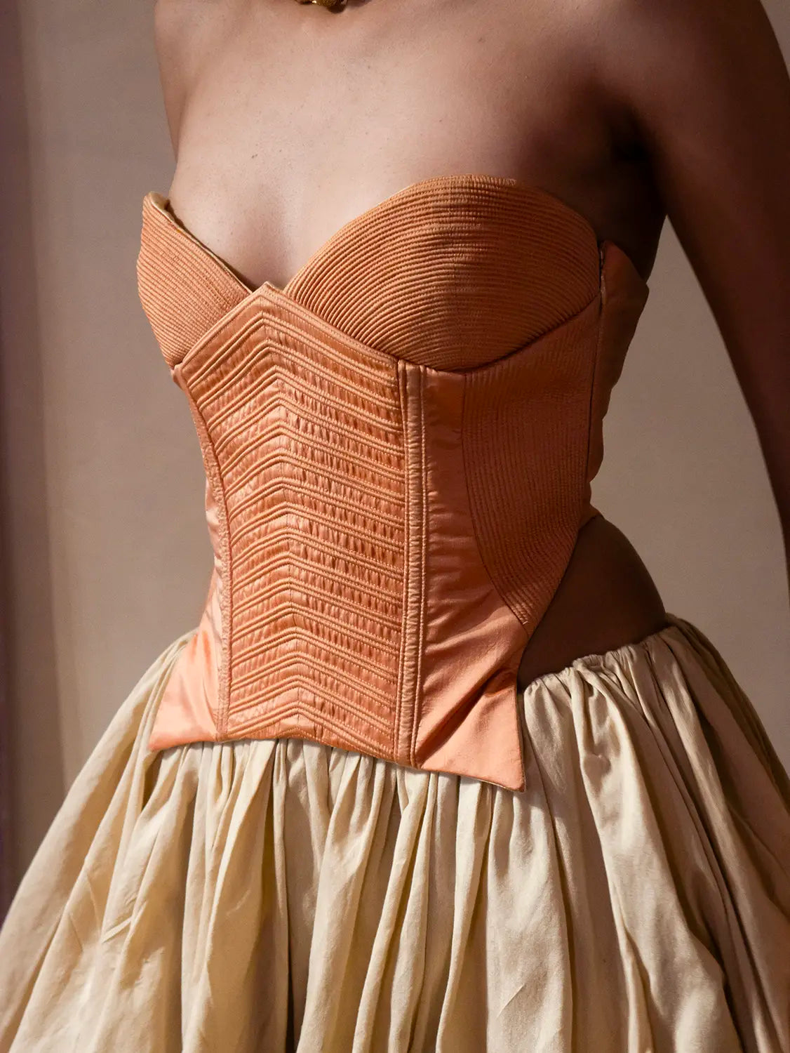 VANA is our one-of-a-kind silk corset, handcrafted in-house using a vintage silk saree. The structured silhouette features intricate hand-done cording details, allowing for a cinched yet refined wear that beautifully adds depth and dimension to the body. Vana is a quiet reflection of meticulous craftsmanship and intentional design.