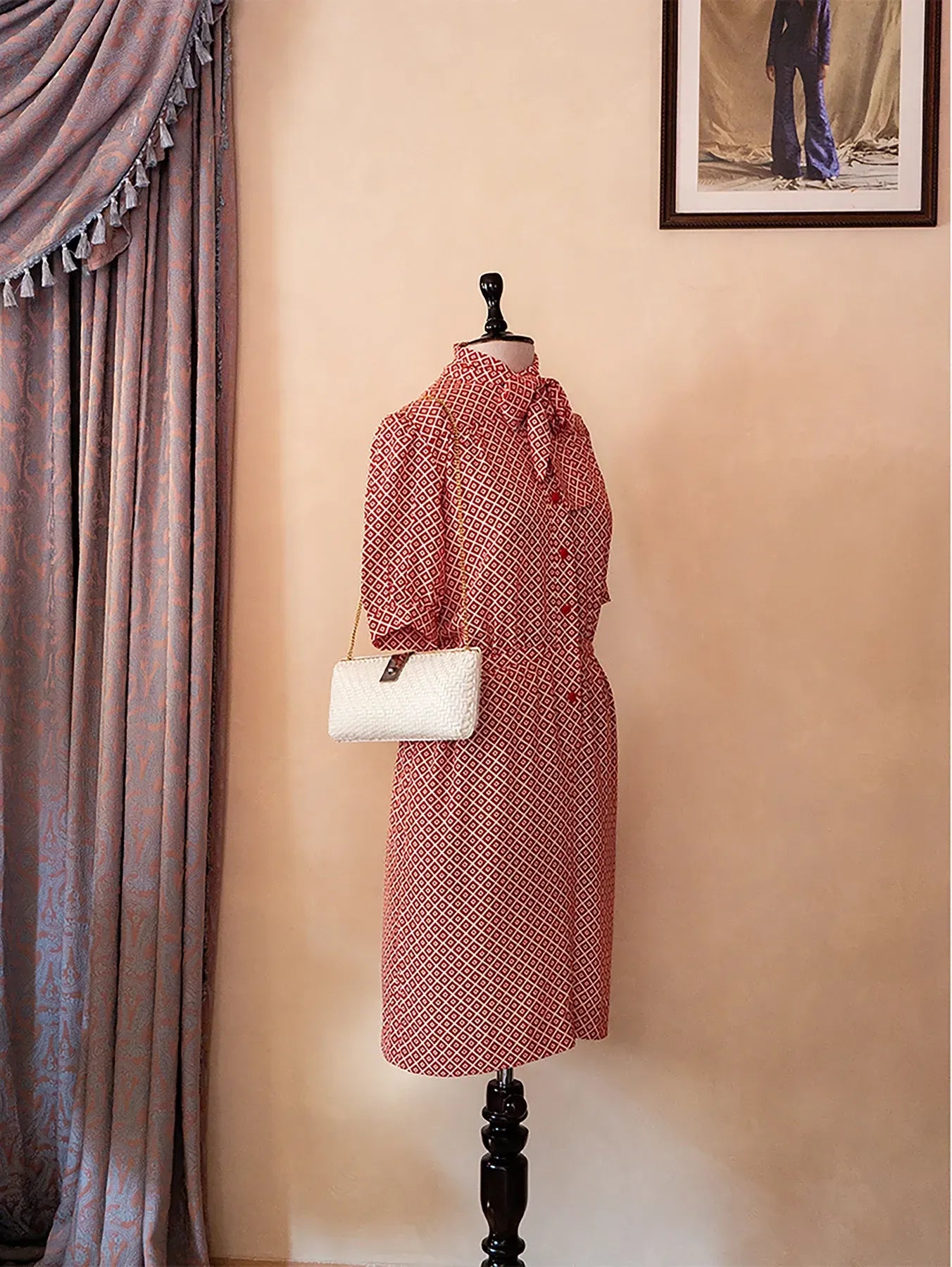 70s vintage Nina Ricci red dress with geometric print, puff sleeves, front buttons, and self-tie neck detail — elegant and easy daywear silhouette.