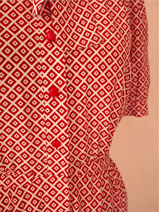70s vintage Nina Ricci red dress with geometric print, puff sleeves, front buttons, and self-tie neck detail — elegant and easy daywear silhouette.