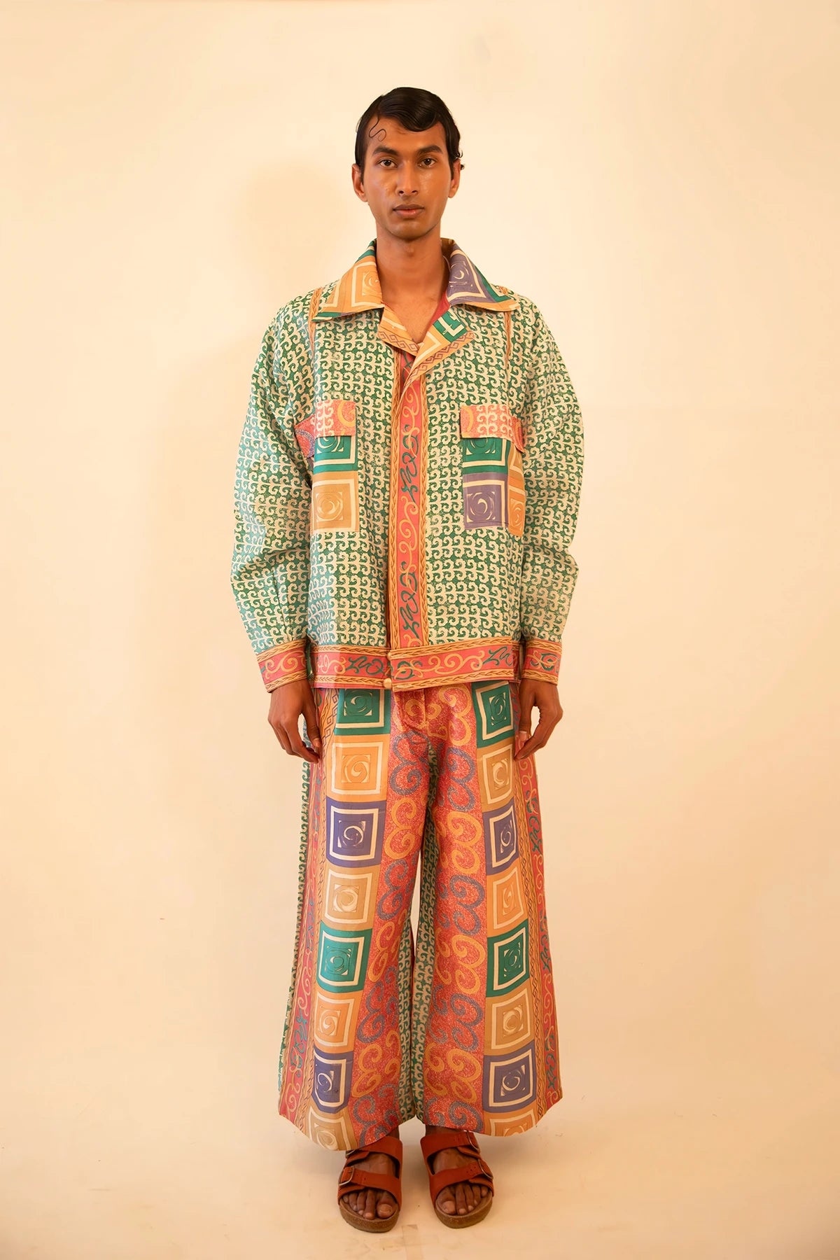 Printed silk bomber and wide-leg pant set with geometric and baroque motifs in light blue and pink, handcrafted from a vintage sari.