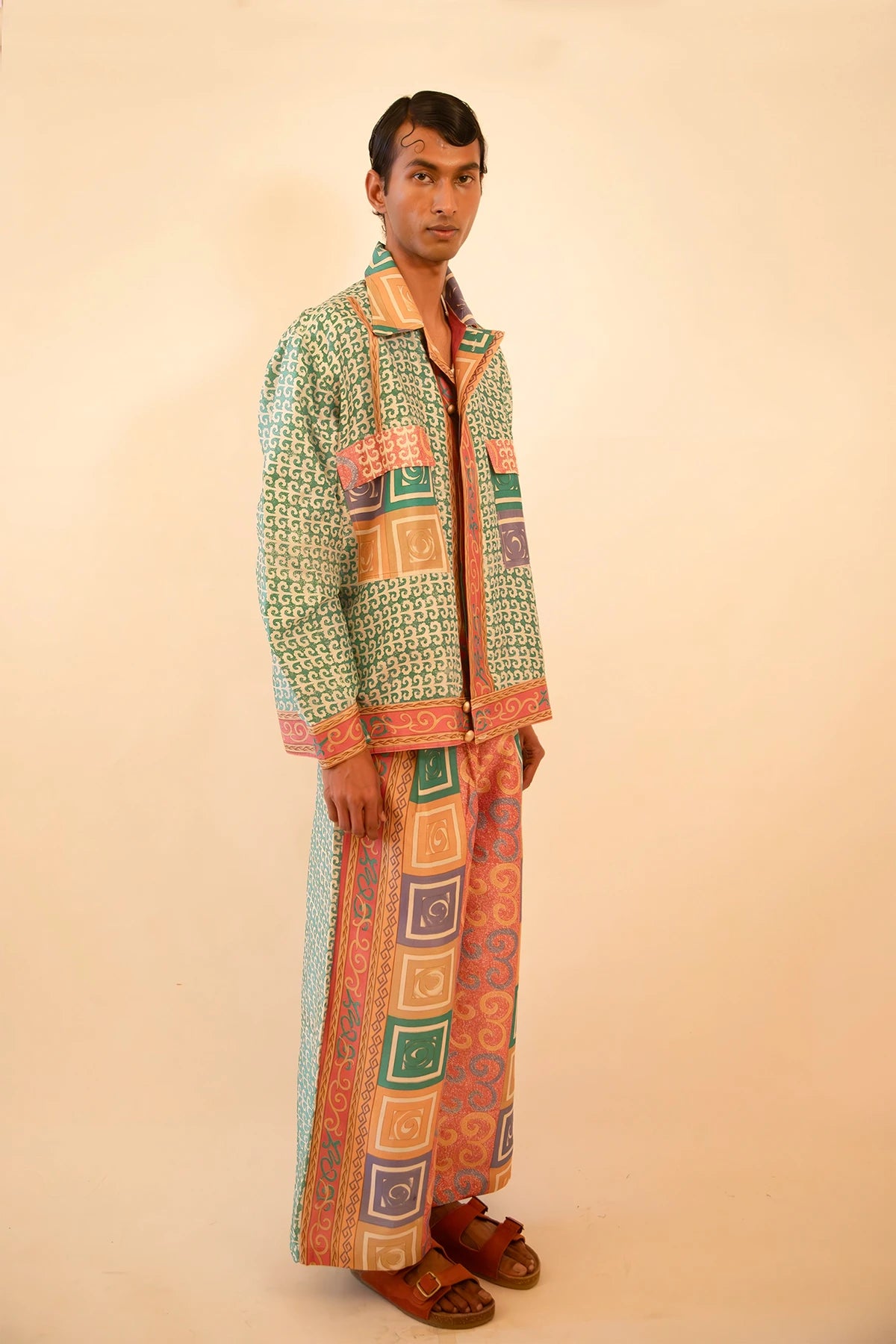 Printed silk bomber and wide-leg pant set with geometric and baroque motifs in light blue and pink, handcrafted from a vintage sari.