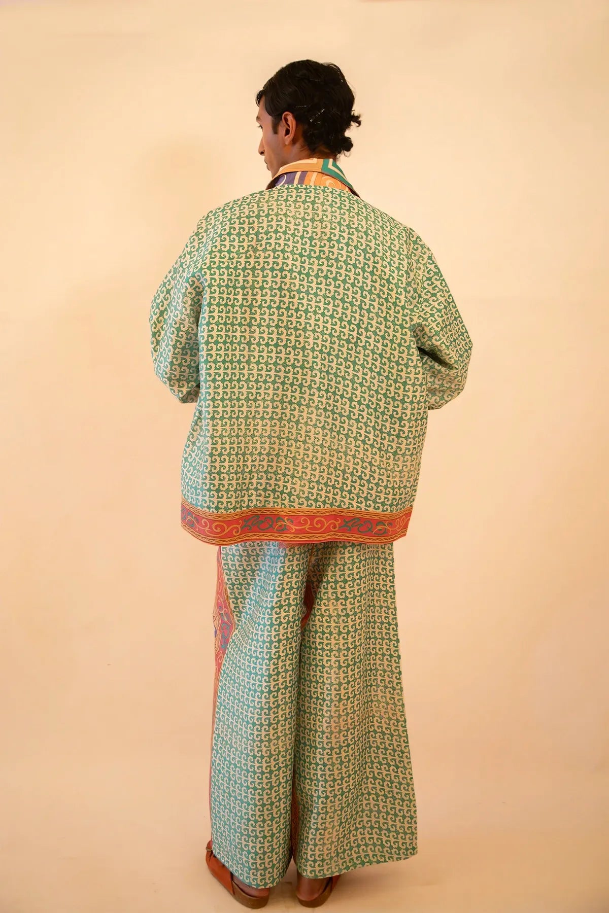 Printed silk bomber and wide-leg pant set with geometric and baroque motifs in light blue and pink, handcrafted from a vintage sari.