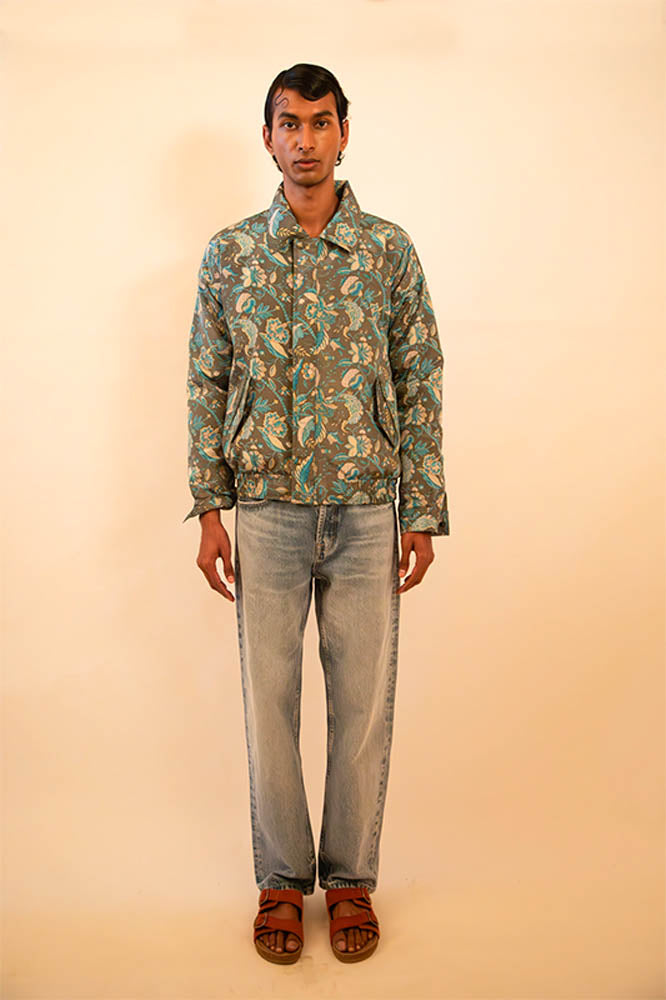 Green paisley silk bomber jacket handcrafted from a vintage sari, lined with soft fleece and finished with a hidden zip detail