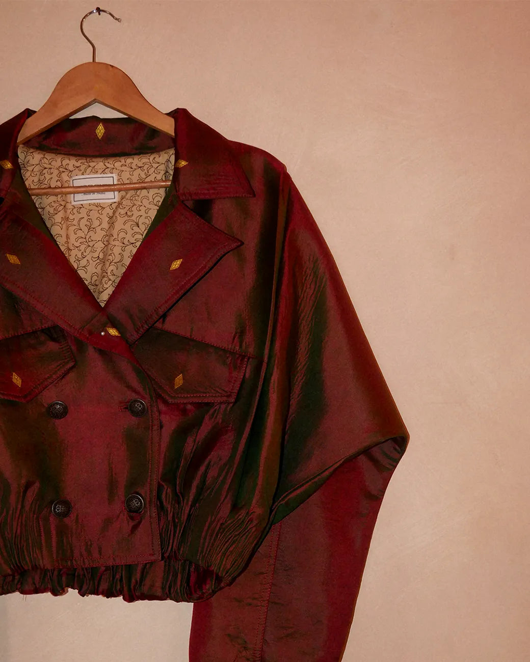 AMBR is our one-of-a-kind cropped two-toned silk brocade reversible bomber, handcrafted by skilled artisans in-house using two vintage silk saris.