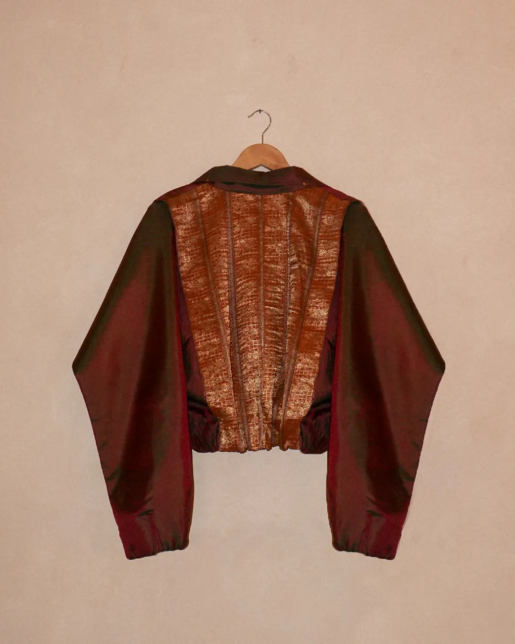 AMBR is our one-of-a-kind cropped two-toned silk brocade reversible bomber, handcrafted by skilled artisans in-house using two vintage silk saris.