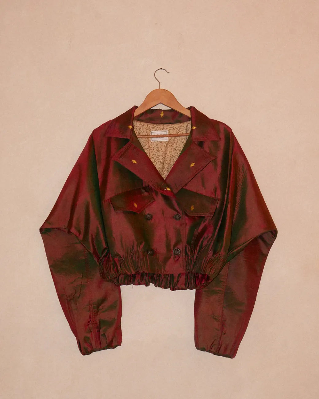 AMBR is our one-of-a-kind cropped two-toned silk brocade reversible bomber, handcrafted by skilled artisans in-house using two vintage silk saris.
