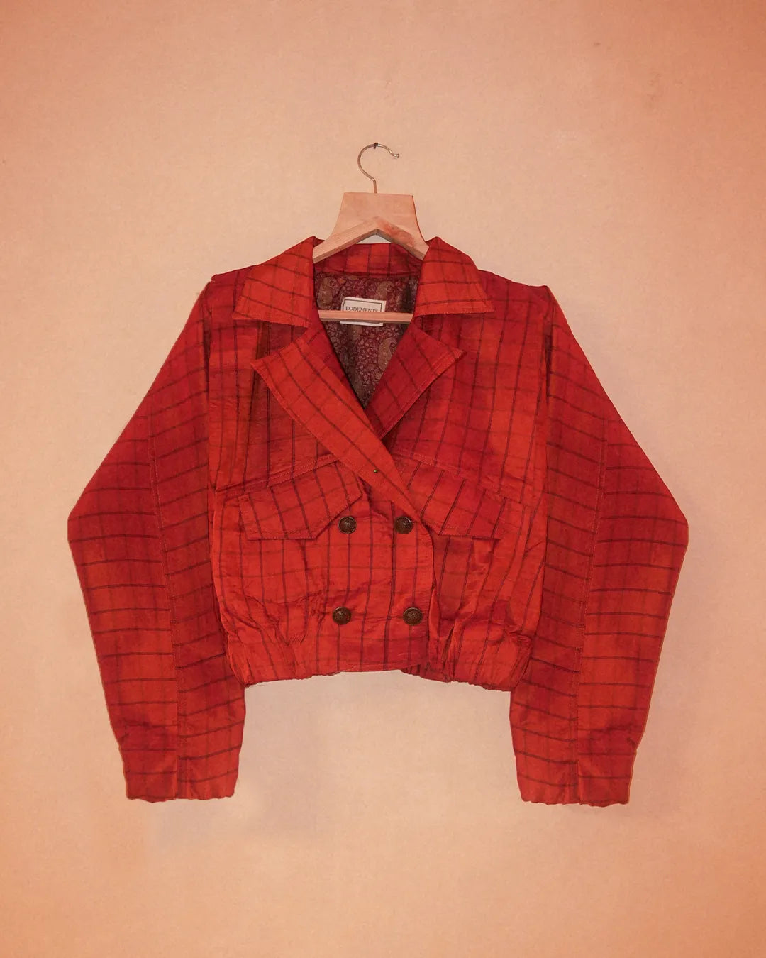 AMBR is our one-of-a-kind cropped two-toned silk brocade&nbsp; bomber jacket, handcrafted by skilled artisans in-house using a vintage silk saris. The back panel features a rich brocade. In our effort to use what already exists, both layers are crafted entirely from vintage textiles. With an exaggerated collar, a slight cinch at the waist, and antique buttons, Ambr stands as a tribute to local craftsmanship and mindful creation.