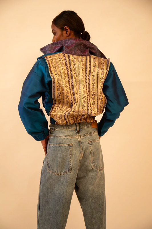 AMBR is our one-of-a-kind cropped two-toned silk brocade&nbsp; bomber jacket, handcrafted by skilled artisans in-house using a vintage silk saris