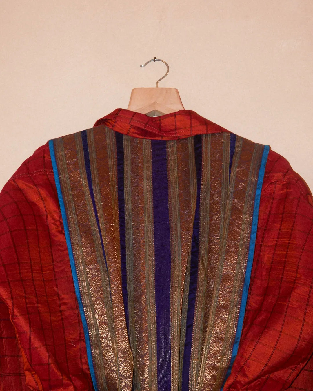 AMBR is our one-of-a-kind cropped two-toned silk brocade&nbsp; bomber jacket, handcrafted by skilled artisans in-house using a vintage silk saris. The back panel features a rich brocade. In our effort to use what already exists, both layers are crafted entirely from vintage textiles. With an exaggerated collar, a slight cinch at the waist, and antique buttons, Ambr stands as a tribute to local craftsmanship and mindful creation.