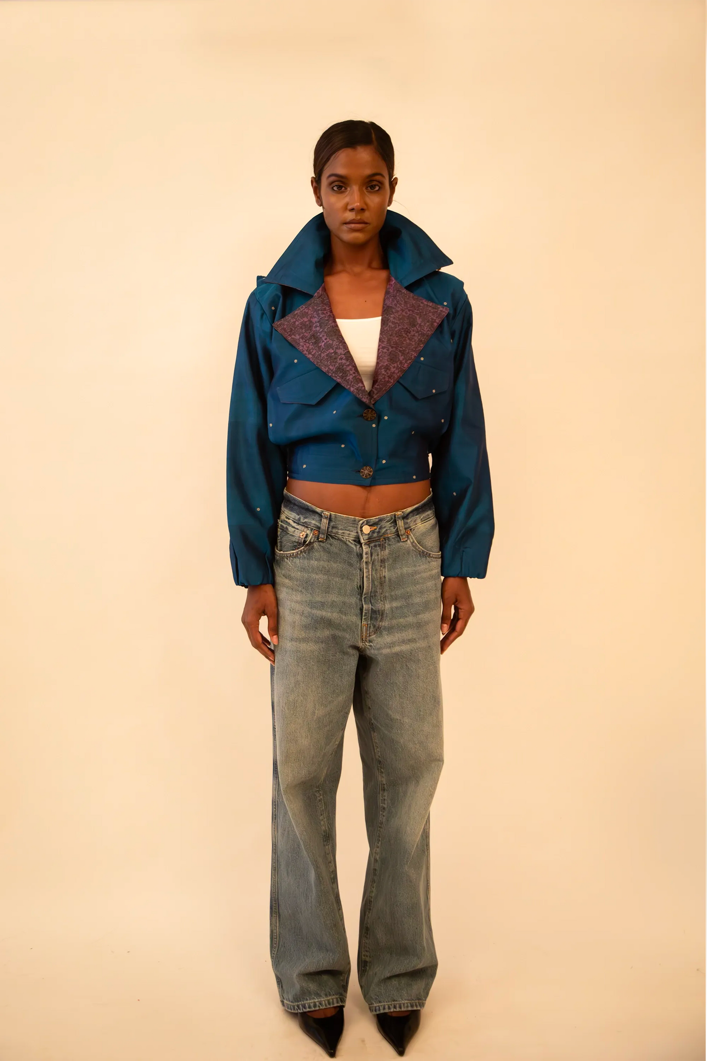 AMBR is our one-of-a-kind cropped two-toned silk brocade&nbsp; bomber jacket, handcrafted by skilled artisans in-house using a vintage silk saris