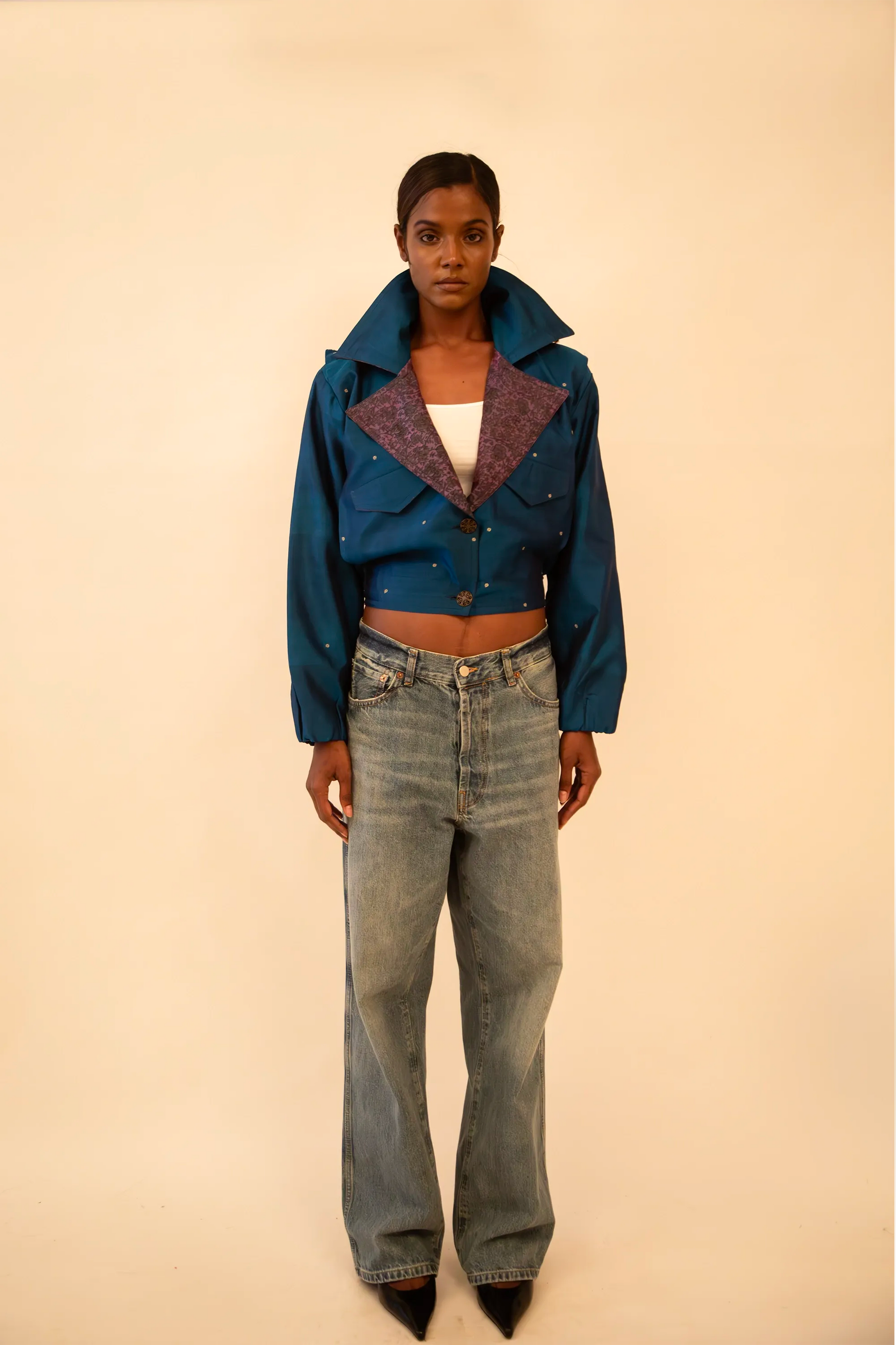 AMBR is our one-of-a-kind cropped two-toned silk brocade&nbsp; bomber jacket, handcrafted by skilled artisans in-house using a vintage silk saris