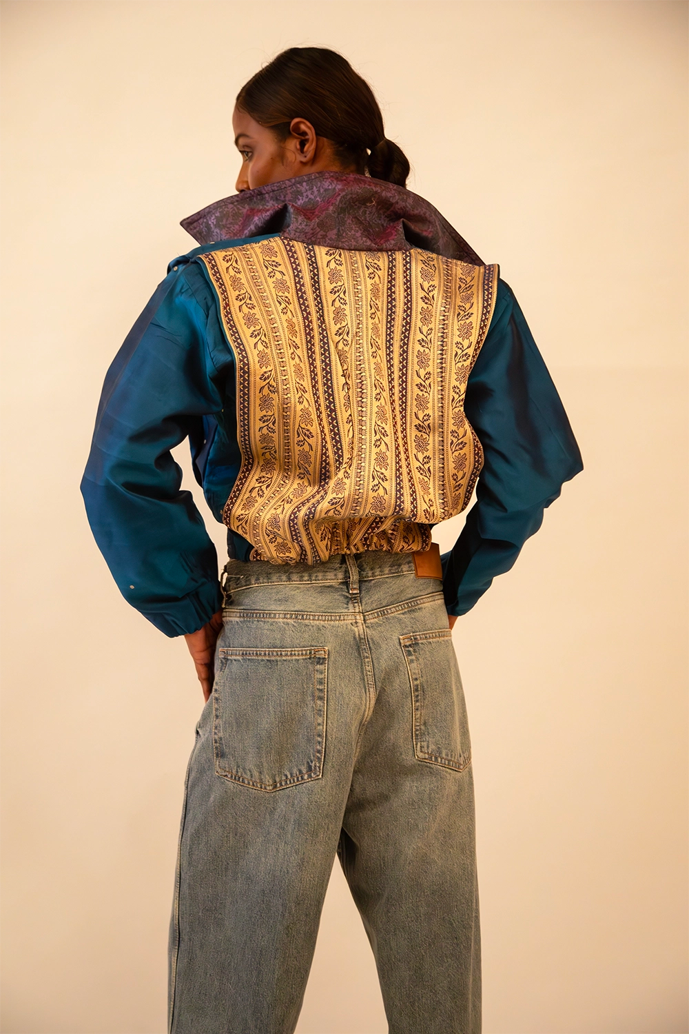 AMBR is our one-of-a-kind cropped two-toned silk brocade&nbsp; bomber jacket, handcrafted by skilled artisans in-house using a vintage silk saris