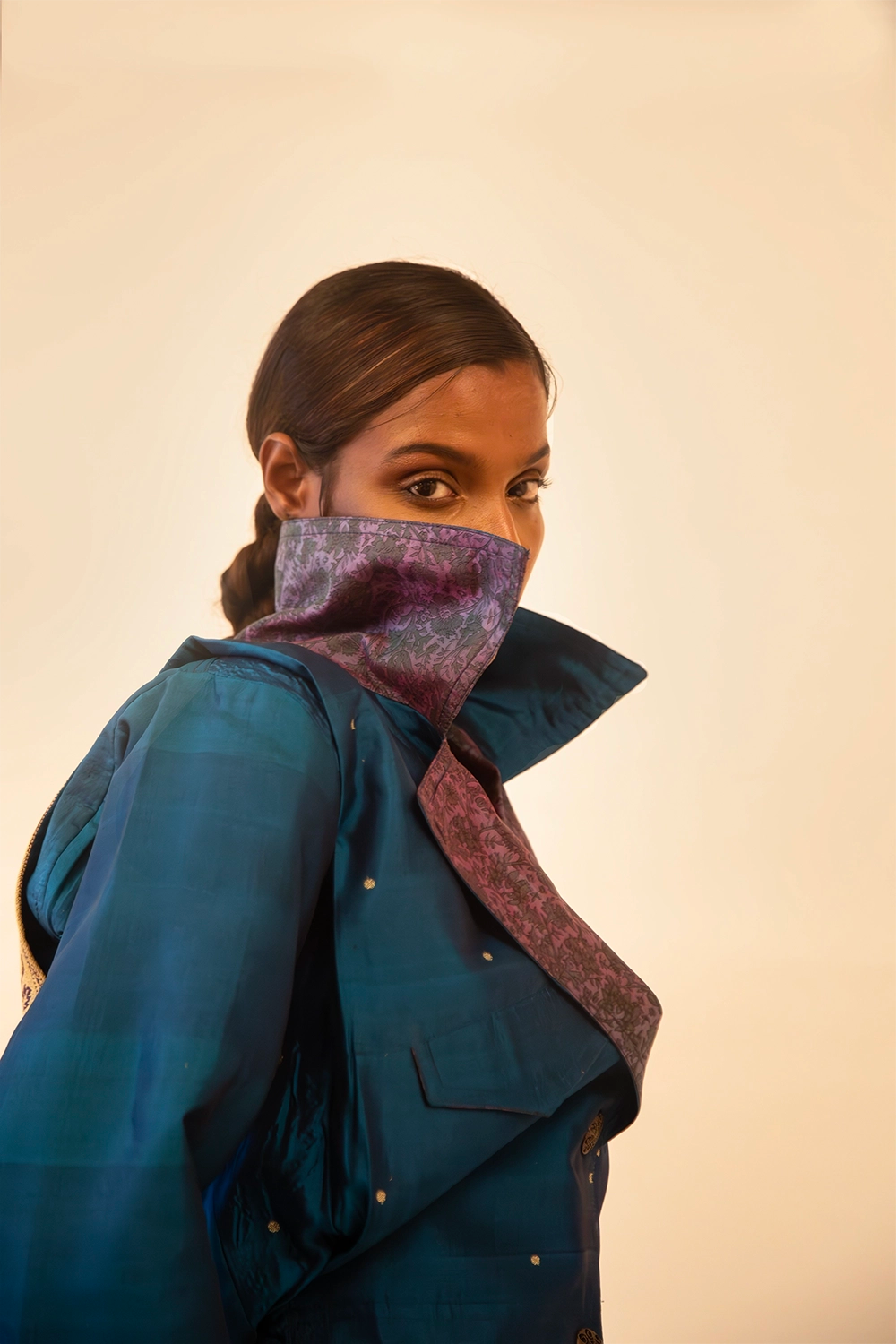 AMBR is our one-of-a-kind cropped two-toned silk brocade&nbsp; bomber jacket, handcrafted by skilled artisans in-house using a vintage silk saris