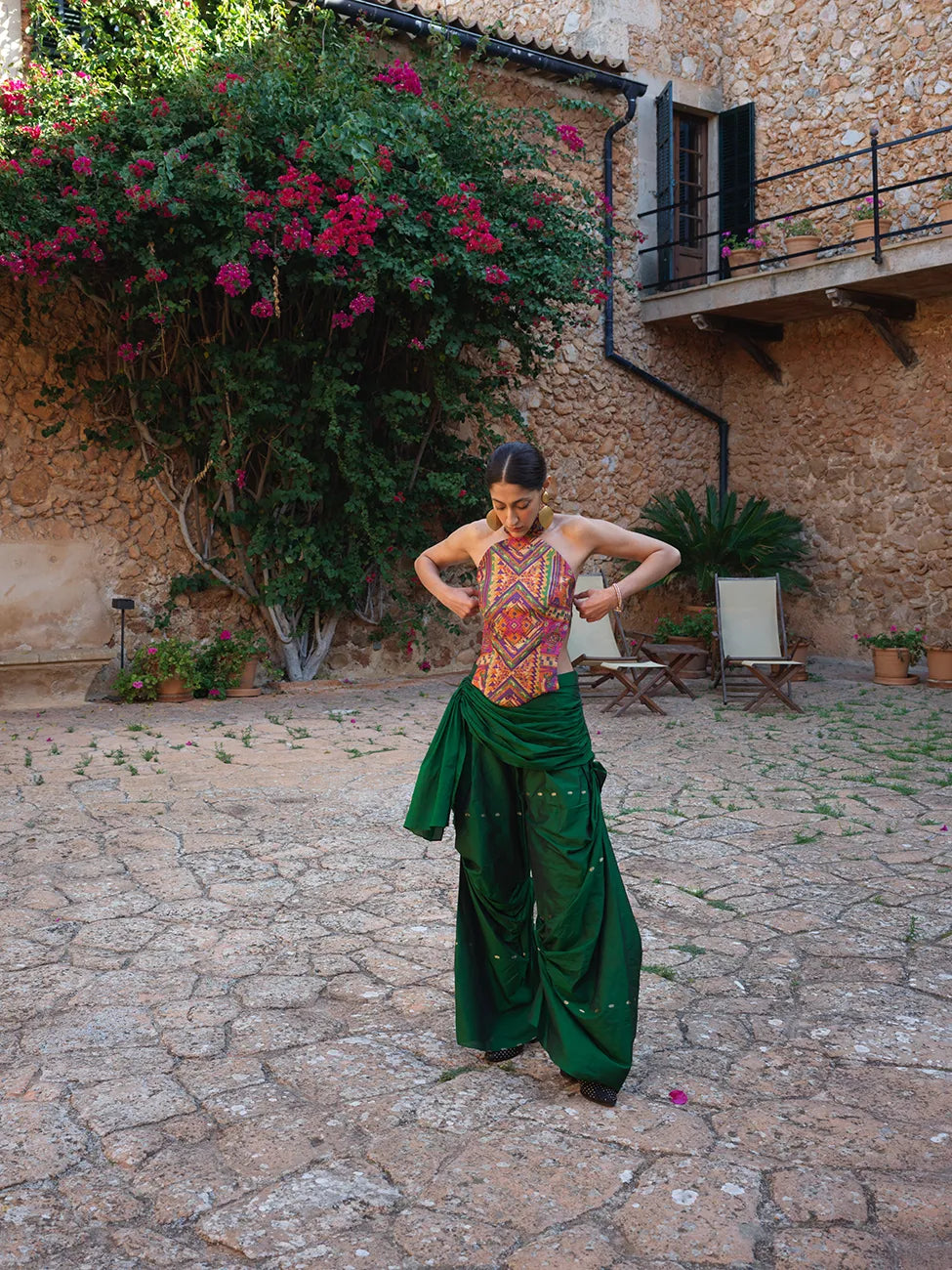 Antariya is our one-of-a-kind drape pants, designed with asymmetrical tucks and fluid folds pinned at varying levels, paired with our backless Apsara Top, held together by Dori ties and high-neck buttons at the back. 