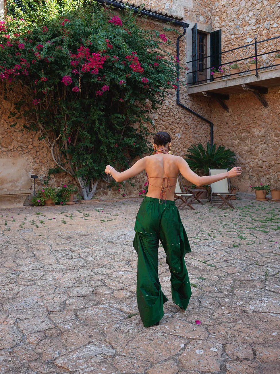 Antariya is our one-of-a-kind drape pants, designed with asymmetrical tucks and fluid folds pinned at varying levels, paired with our backless Apsara Top, held together by Dori ties and high-neck buttons at the back. 