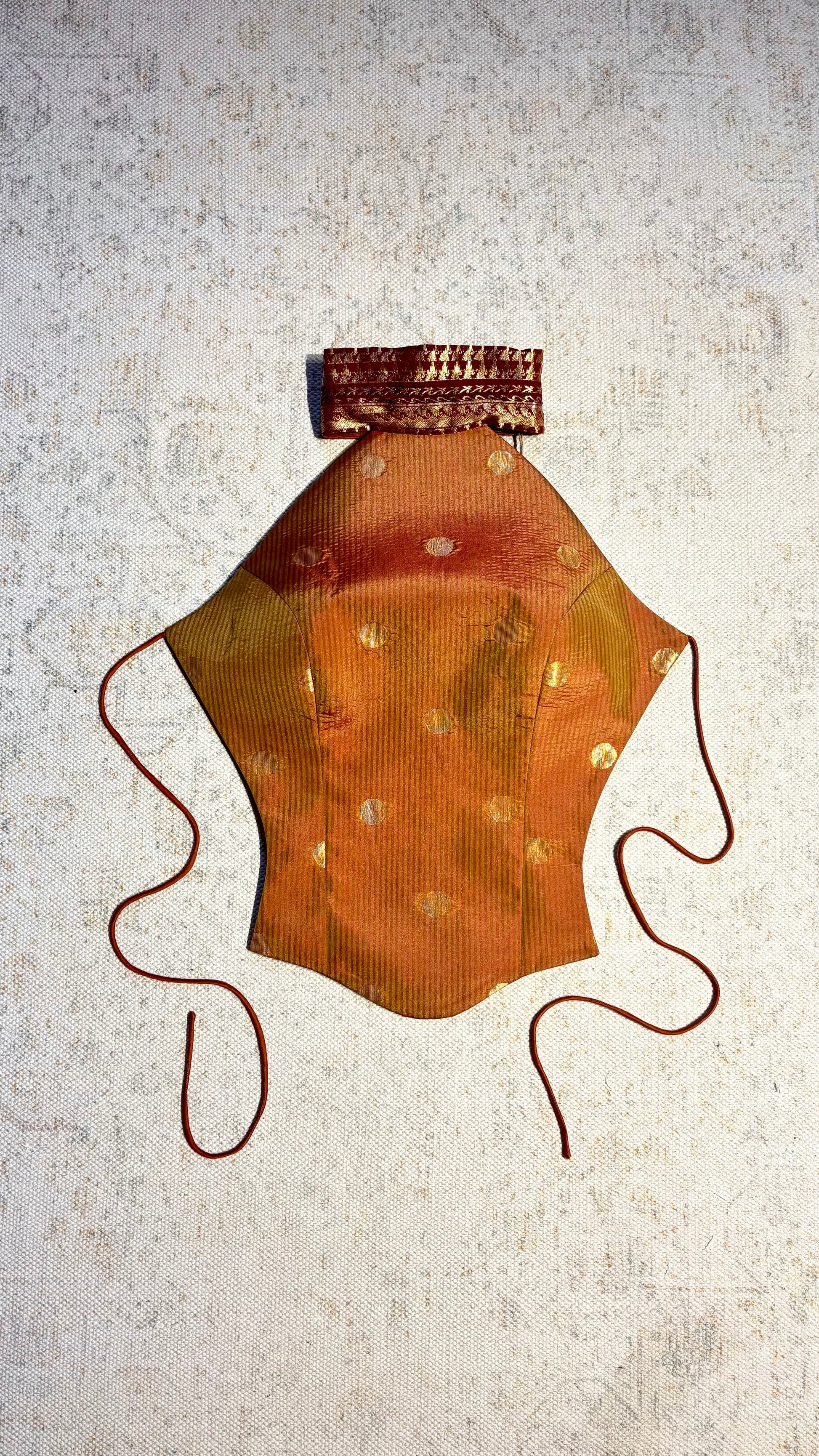 APSARA VII is our high-neck, backless top crafted from a vintage silk saree, inhouse by skilled artisans.