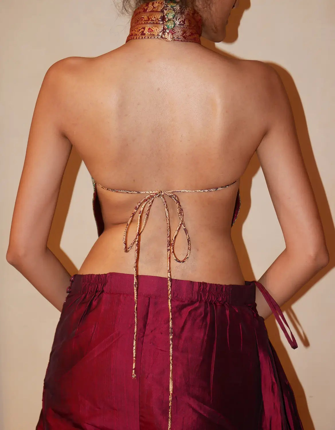 APSARA VIII.II is our high-neck, backless top crafted from a vintage silk saree, inhouse by skilled artisans. 