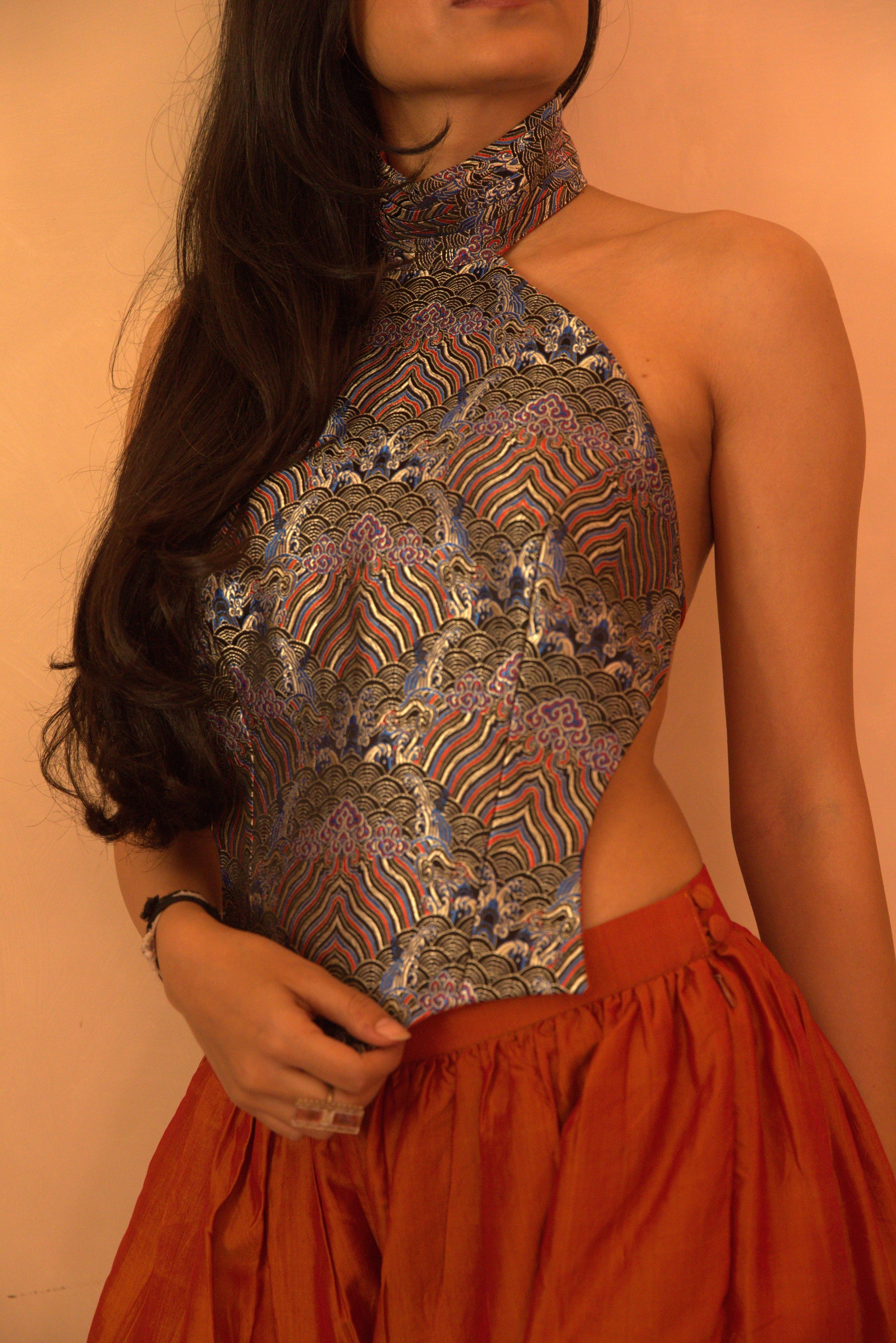 APSARA VI is our high-neck, backless top crafted from a vintage silk saree, inhouse by skilled artisans. 