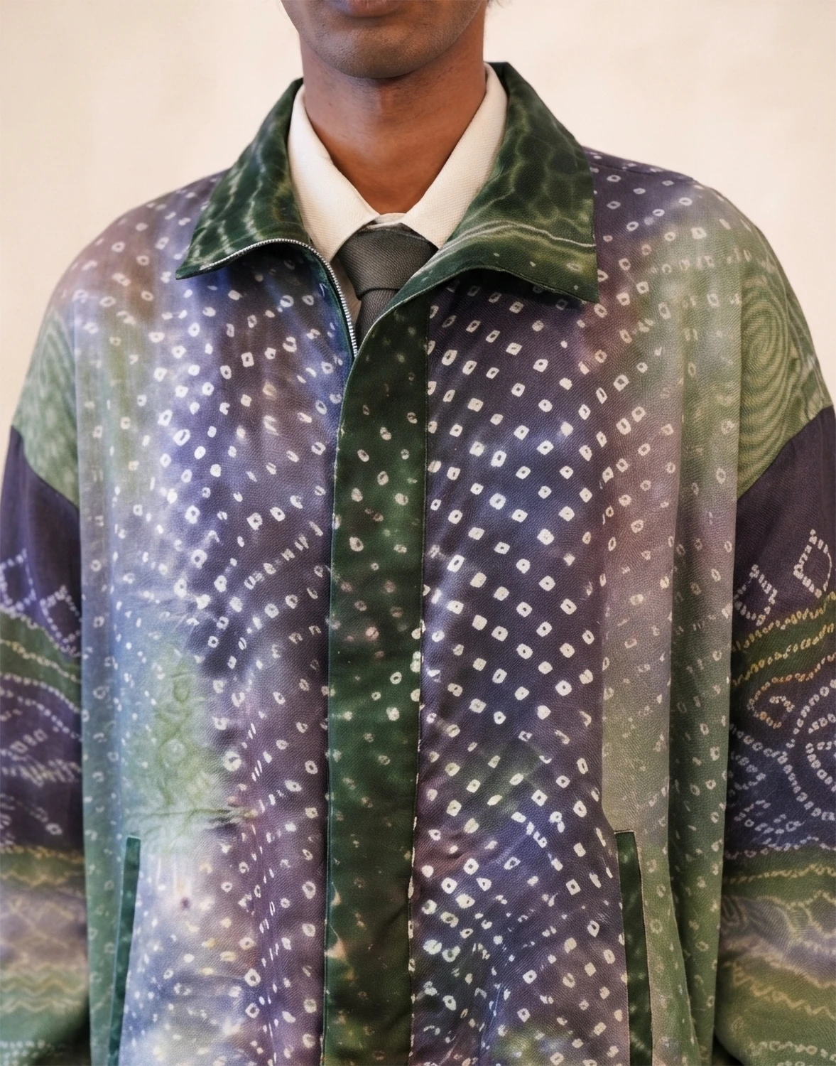 The bomber is a printed silk bomber jacket handcrafted in house from two one of a kind vintage Bandhani sareesThe bomber is a printed silk bomber jacket handcrafted in house from two one of a kind vintage Bandhani sarees