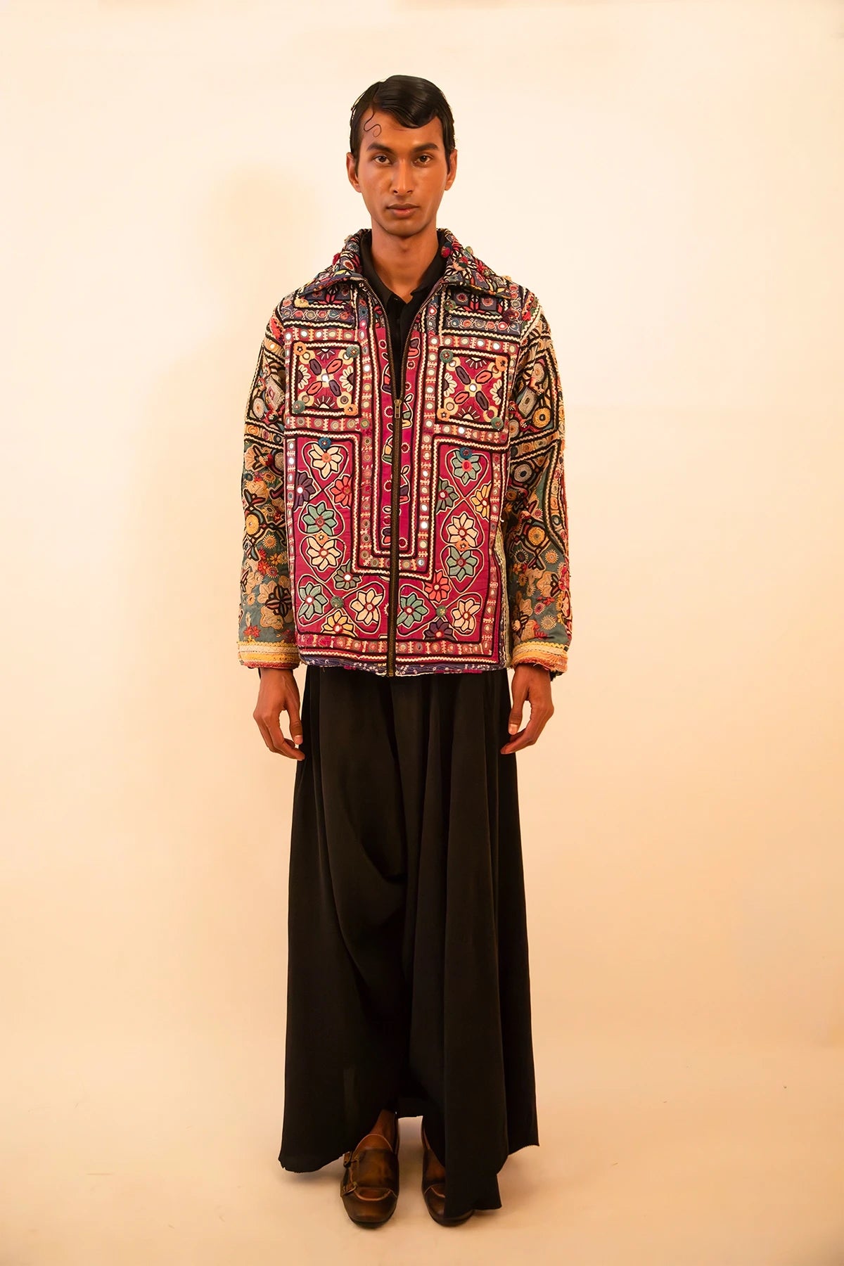 One-of-a-kind jacket handcrafted from traditional Rabari cholas panelled together, lined with a vintage silk sari, featuring a boxy fit with dropped shoulders.