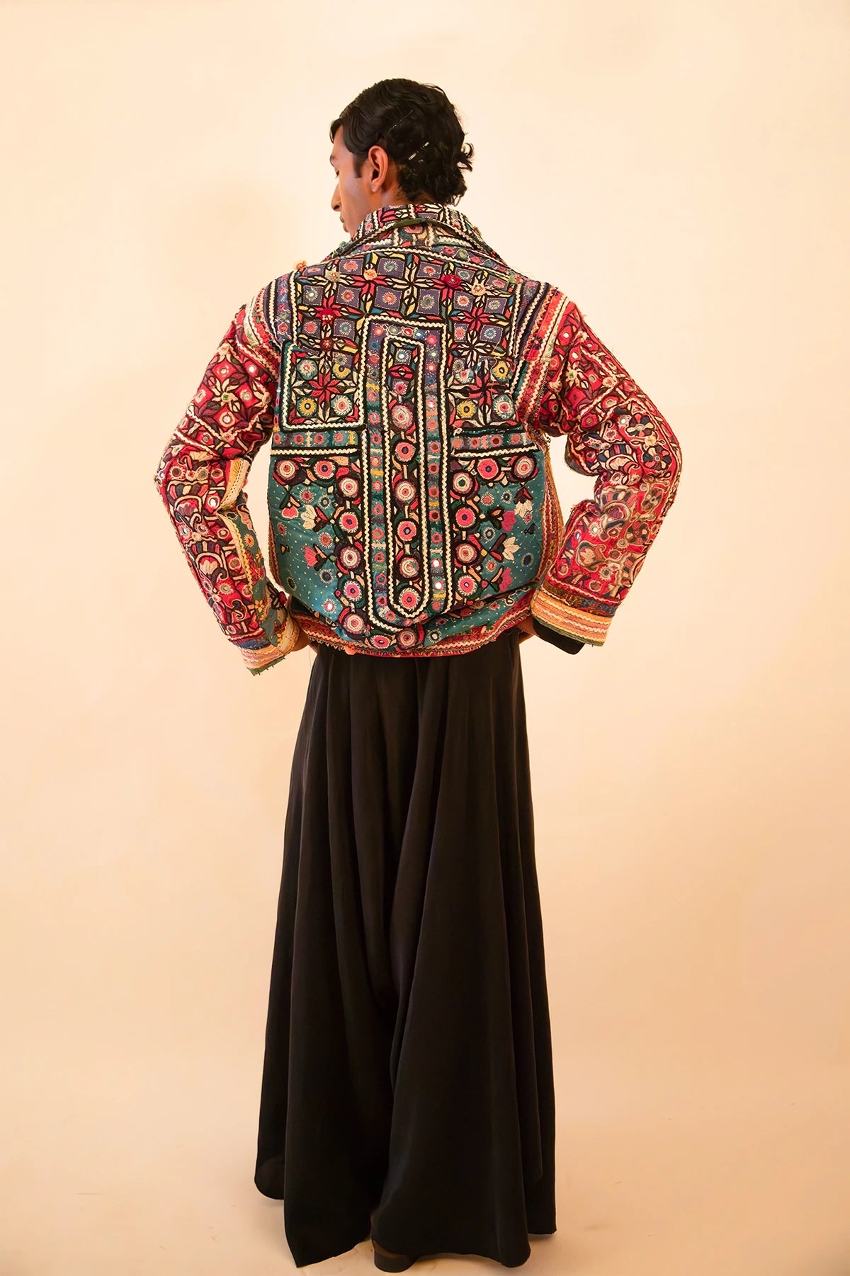 One-of-a-kind jacket handcrafted from traditional Rabari cholas panelled together, lined with a vintage silk sari, featuring a boxy fit with dropped shoulders.