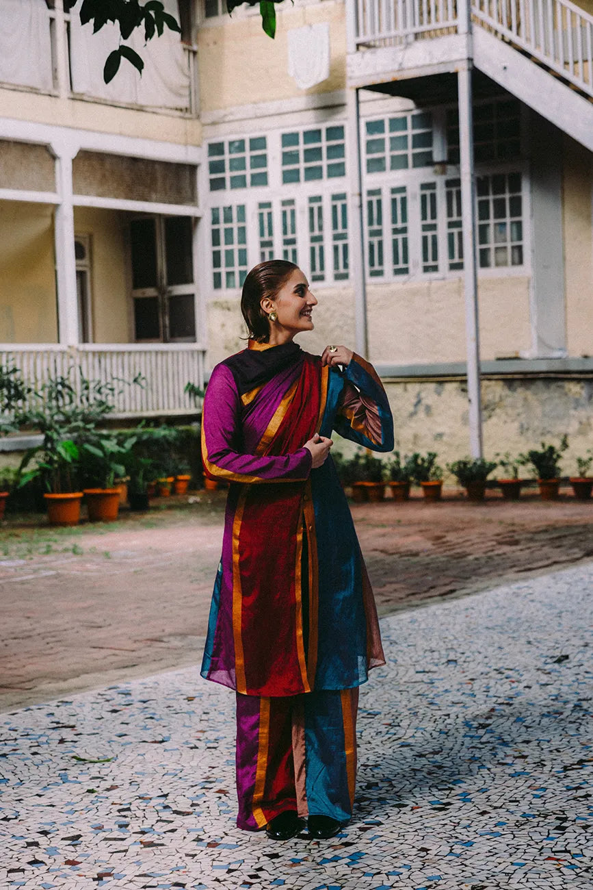 Drapa set with sari-inspired trench and dupatta detail in earthy jewel tones with gold accents.