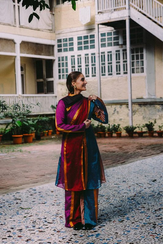 Drapa set with sari-inspired trench and dupatta detail in earthy jewel tones with gold accents.