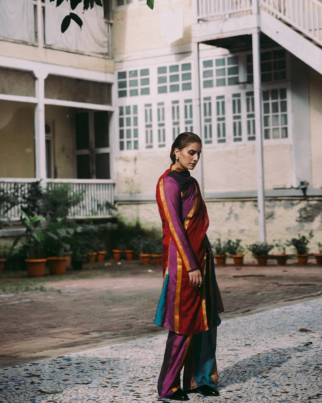 Drapa set with sari-inspired trench and dupatta detail in earthy jewel tones with gold accents.
