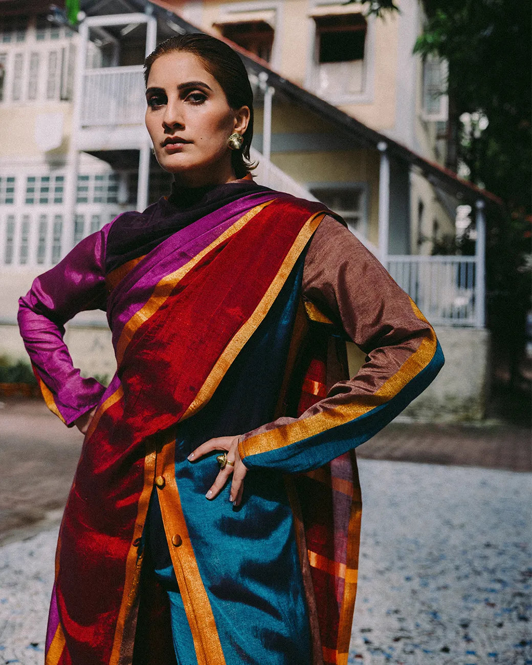 Drapa set with sari-inspired trench and dupatta detail in earthy jewel tones with gold accents.