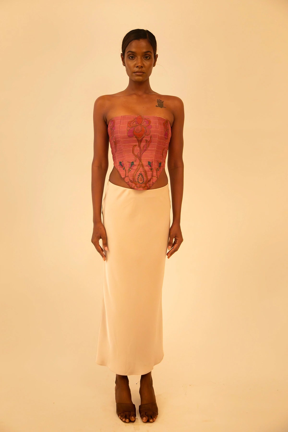 Handcrafted strapless corset made from upcycled vintage silk sari, a structured silhouette, celebrating artisanal craftsmanship and conscious design.