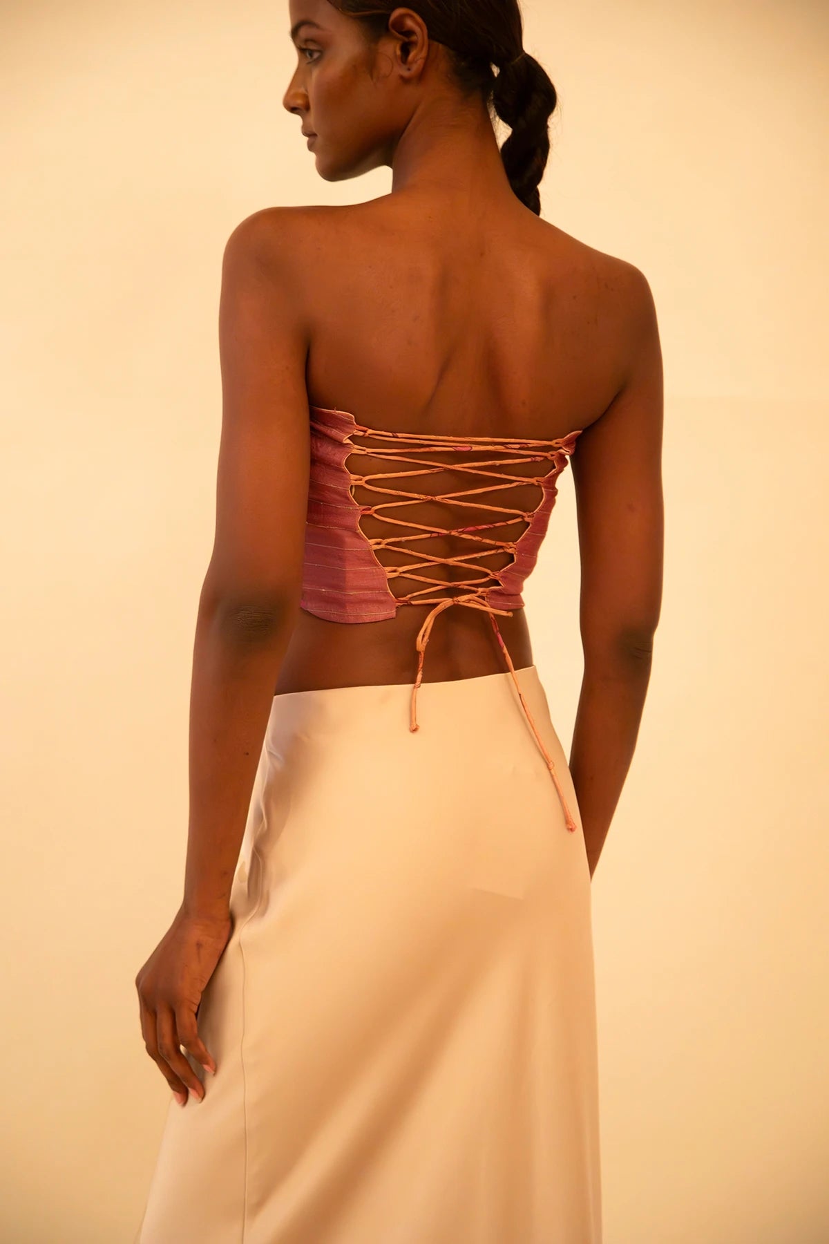 Handcrafted strapless corset made from upcycled vintage silk sari, a structured silhouette, celebrating artisanal craftsmanship and conscious design.