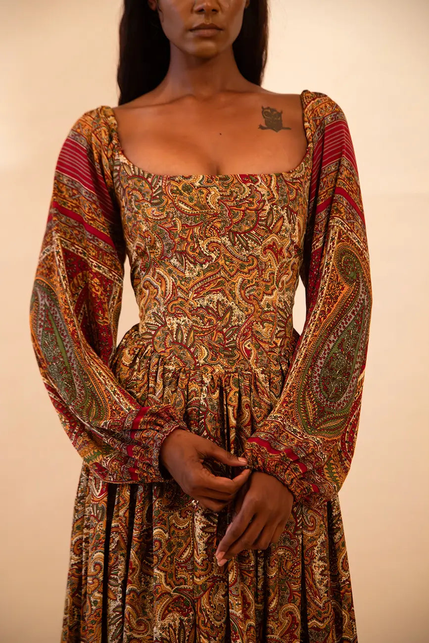 IRA our one of a kind, brown printed maxi dress. the garment comprises of puff sleeve and a back tie 