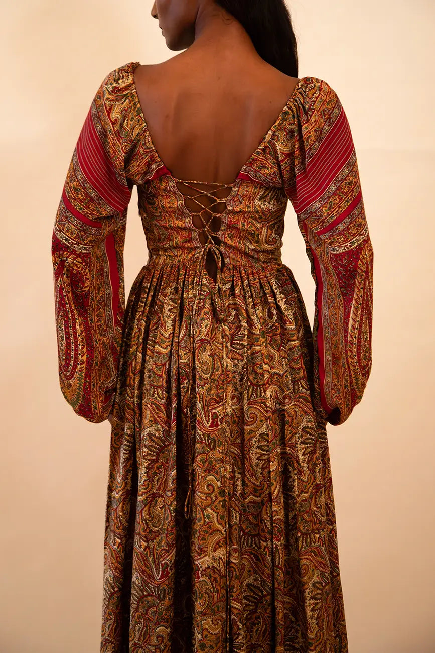 IRA our one of a kind, brown printed maxi dress. the garment comprises of puff sleeve and a back tie 