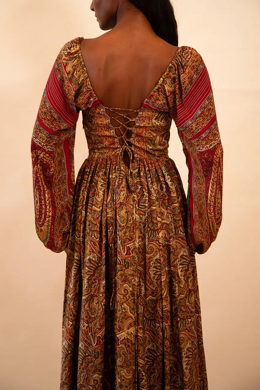 IRA our one of a kind, brown printed maxi dress. the garment comprises of puff sleeve and a back tie 