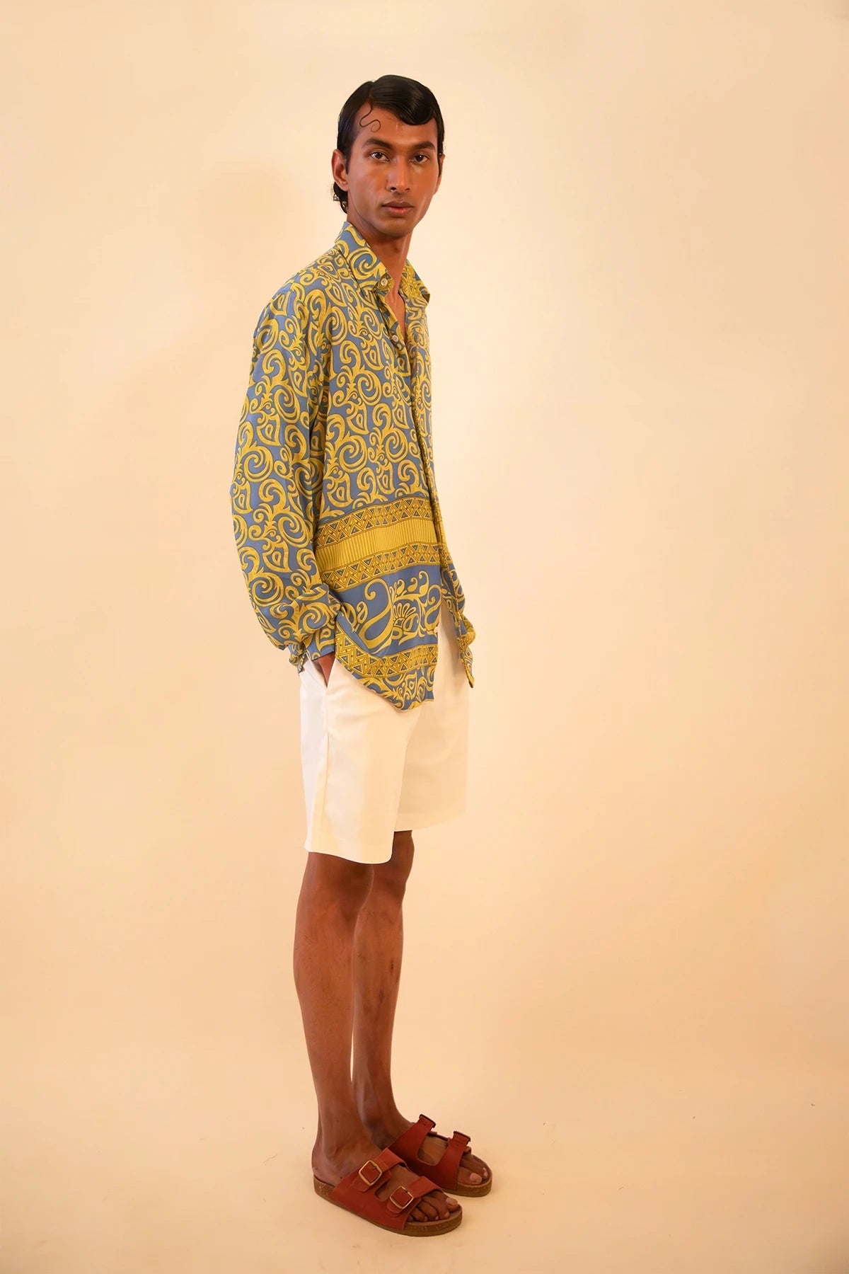 Baroque-printed silk shirt handcrafted from a vintage sari, featuring a relaxed unisex fit, full sleeves, contrast piping, and a soft drape, celebrating slow fashion and timeless craft.