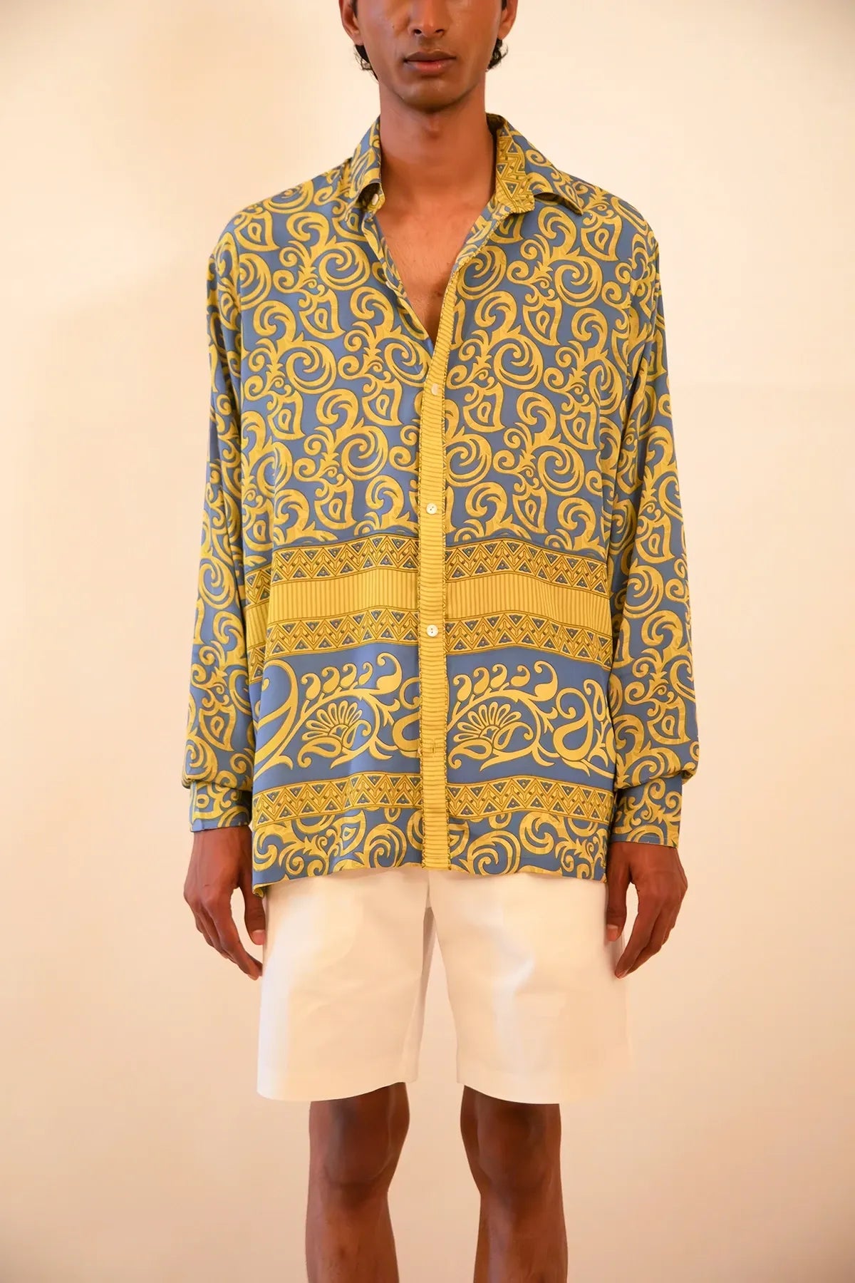 Baroque-printed silk shirt handcrafted from a vintage sari, featuring a relaxed unisex fit, full sleeves, contrast piping, and a soft drape, celebrating slow fashion and timeless craft.