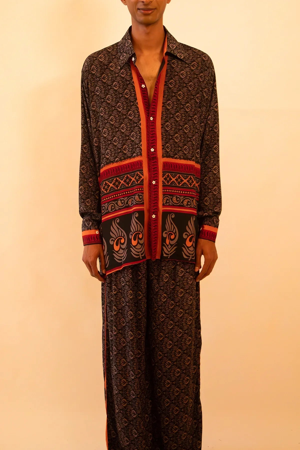 Black and red silk shirt and pant set handcrafted from a vintage sari, featuring a relaxed fit, soft breathable texture, and contrast button detailing