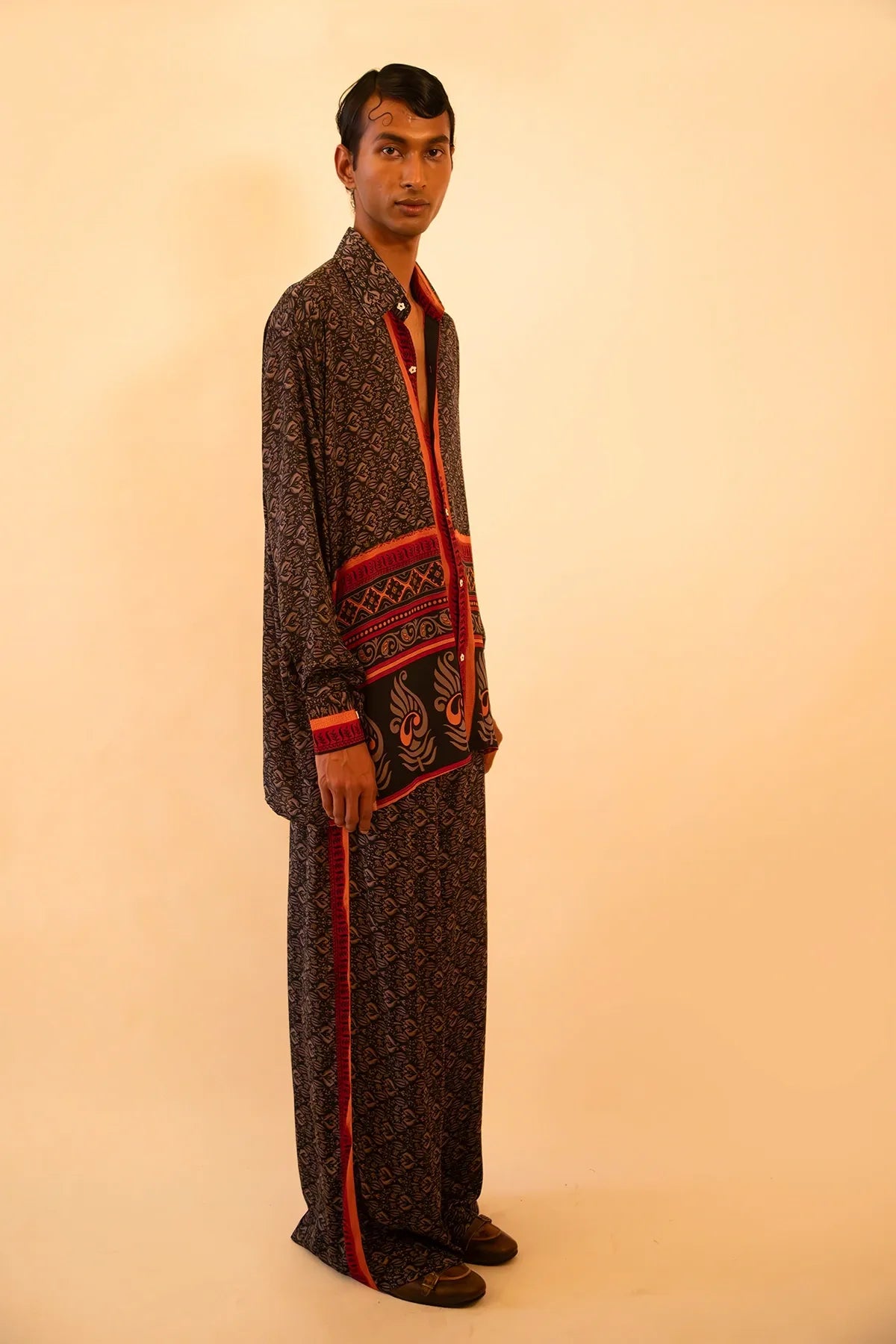 Black and red silk shirt and pant set handcrafted from a vintage sari, featuring a relaxed fit, soft breathable texture, and contrast button detailing