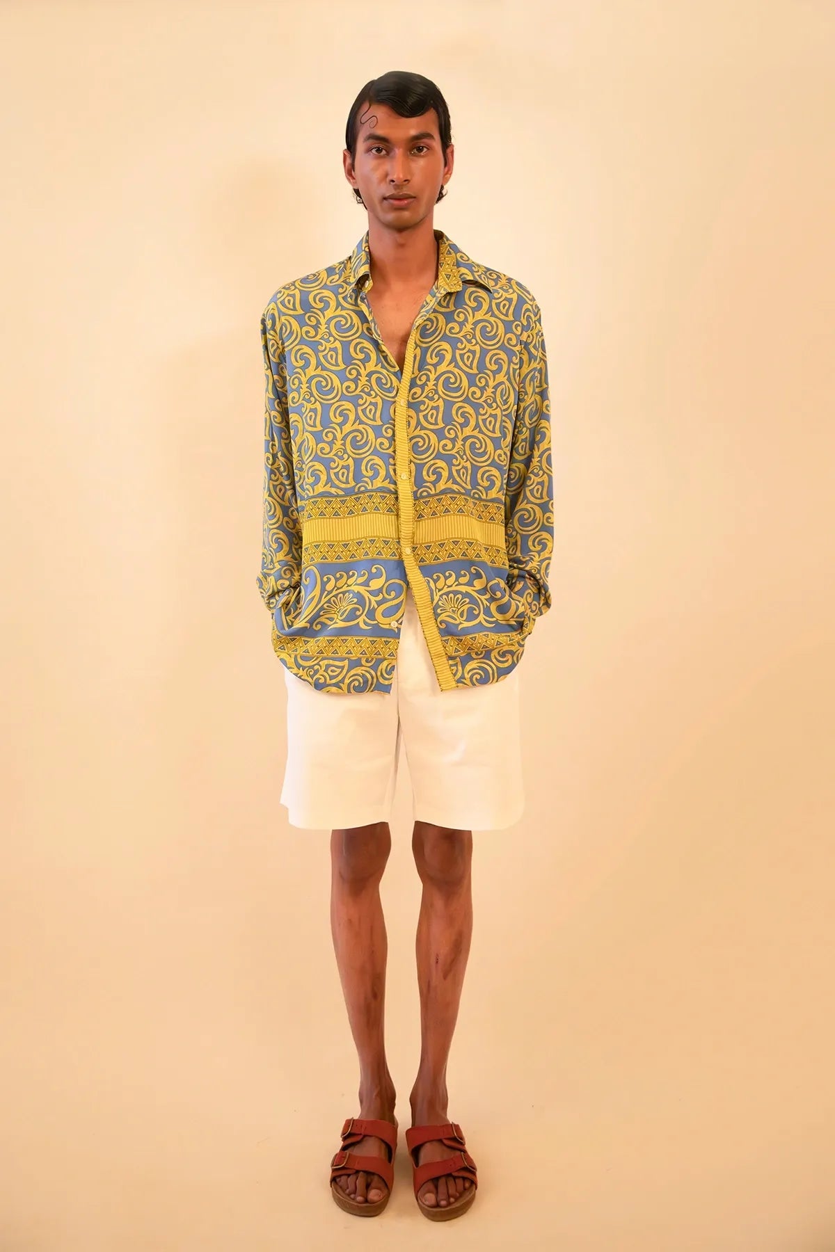 Baroque-printed silk shirt handcrafted from a vintage sari, featuring a relaxed unisex fit, full sleeves, contrast piping, and a soft drape, celebrating slow fashion and timeless craft.