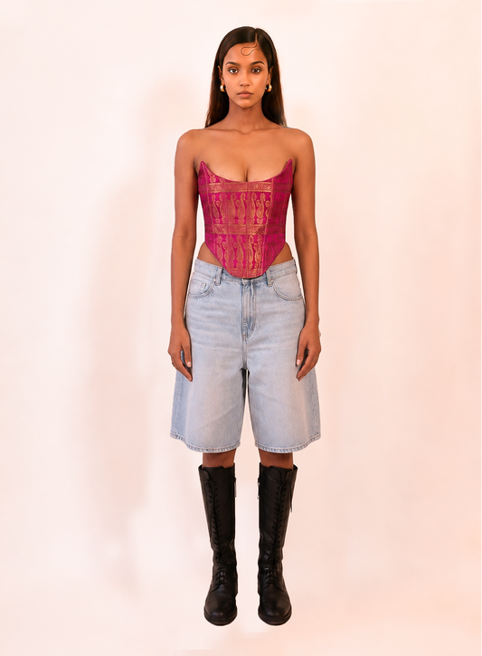 MADHU is our one of a kind corset made in house by skilled artisans using rich silk brocade in a vibrant fuchsia pink with intricate golden motifs. 