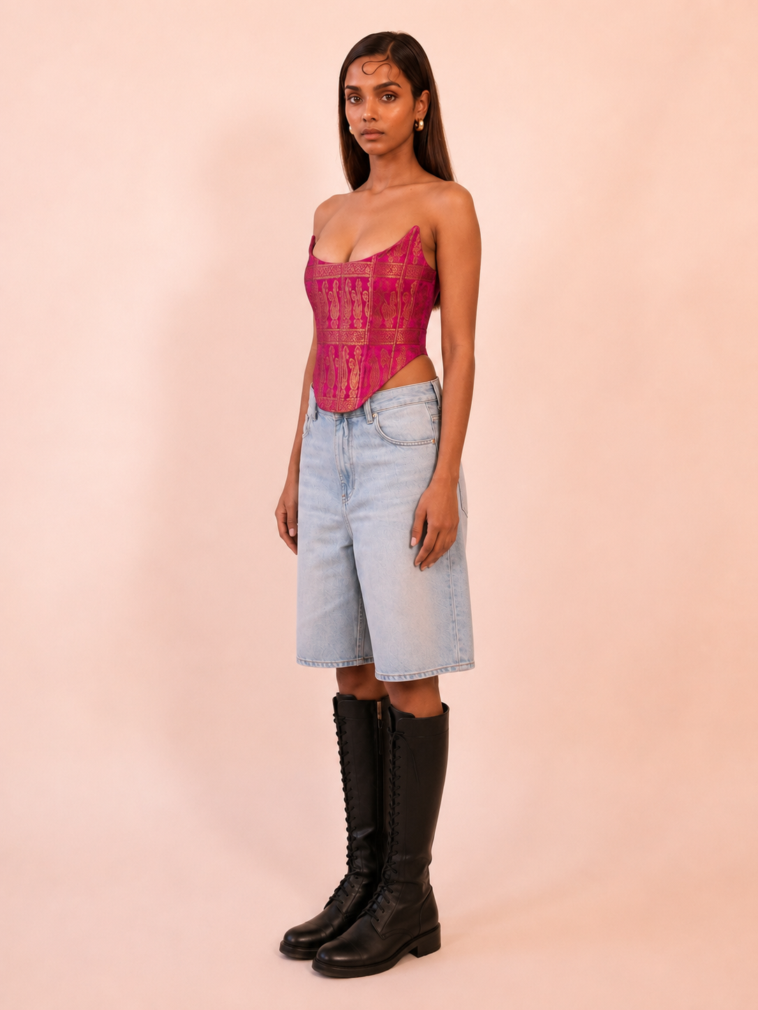 MADHU is our one of a kind corset made in house by skilled artisans using rich silk brocade in a vibrant fuchsia pink with intricate golden motifs. 