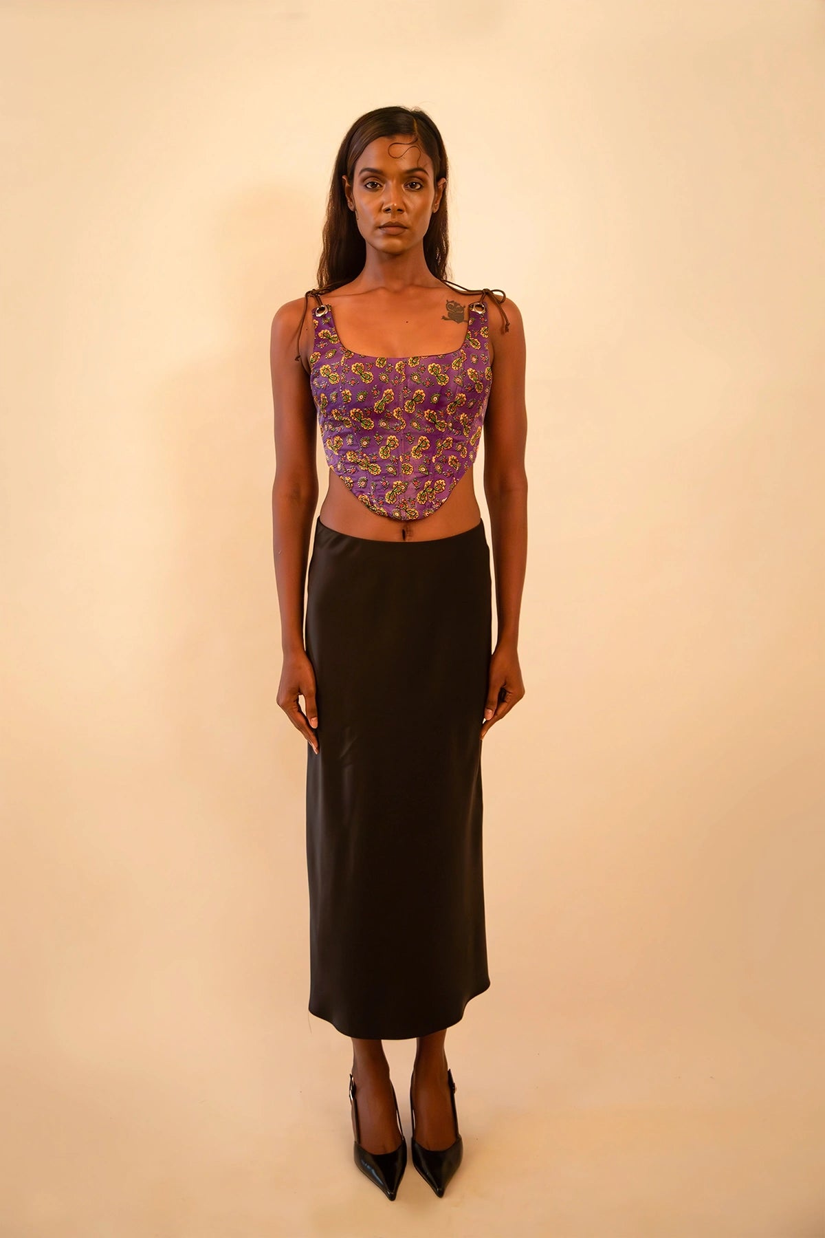 Purple printed silk corset with adjustable straps, handcrafted from a vintage sari, featuring intricate motifs, structured fit, smocking detail, and metal back zipper.