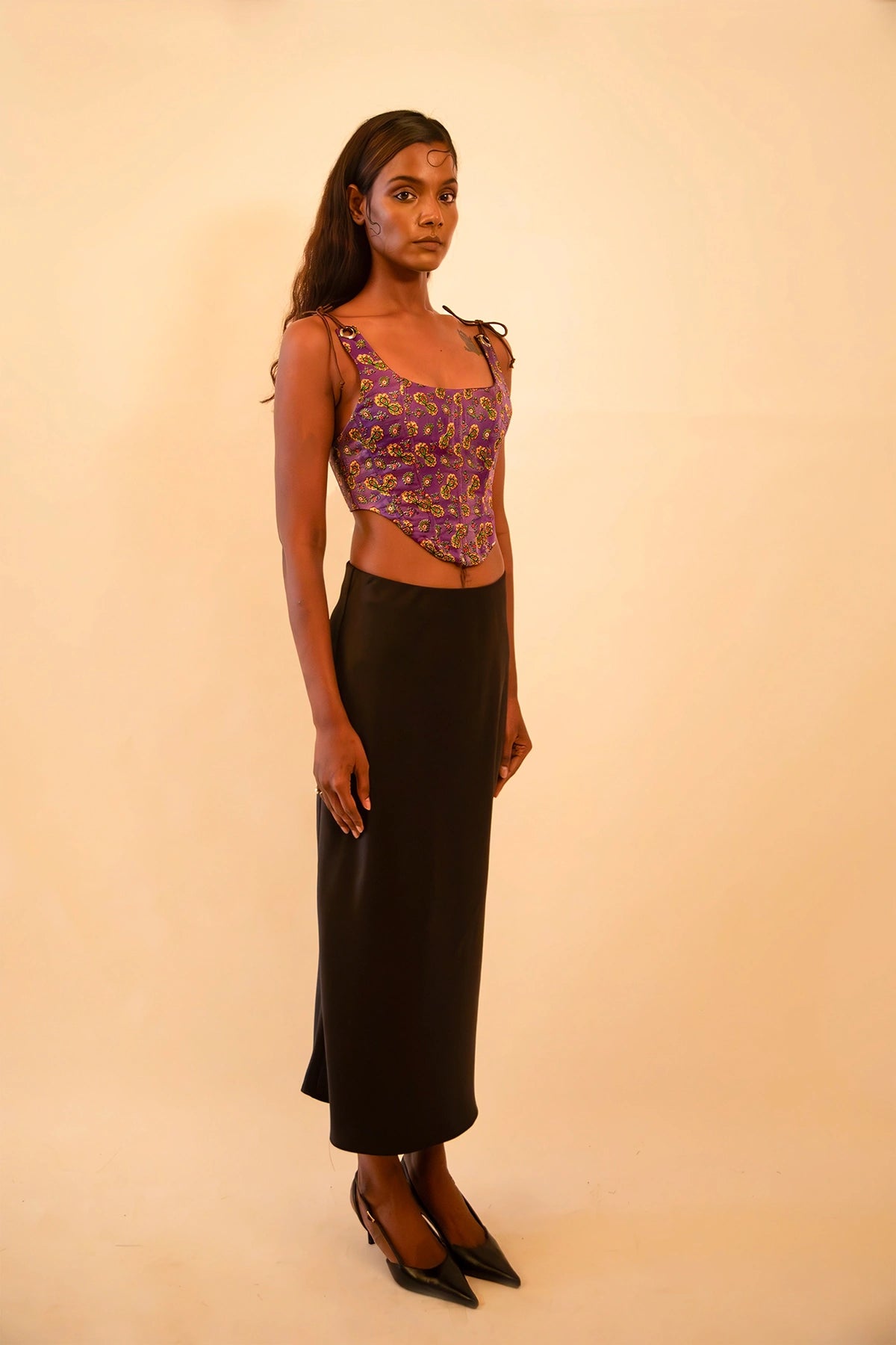 Purple printed silk corset with adjustable straps, handcrafted from a vintage sari, featuring intricate motifs, structured fit, smocking detail, and metal back zipper.