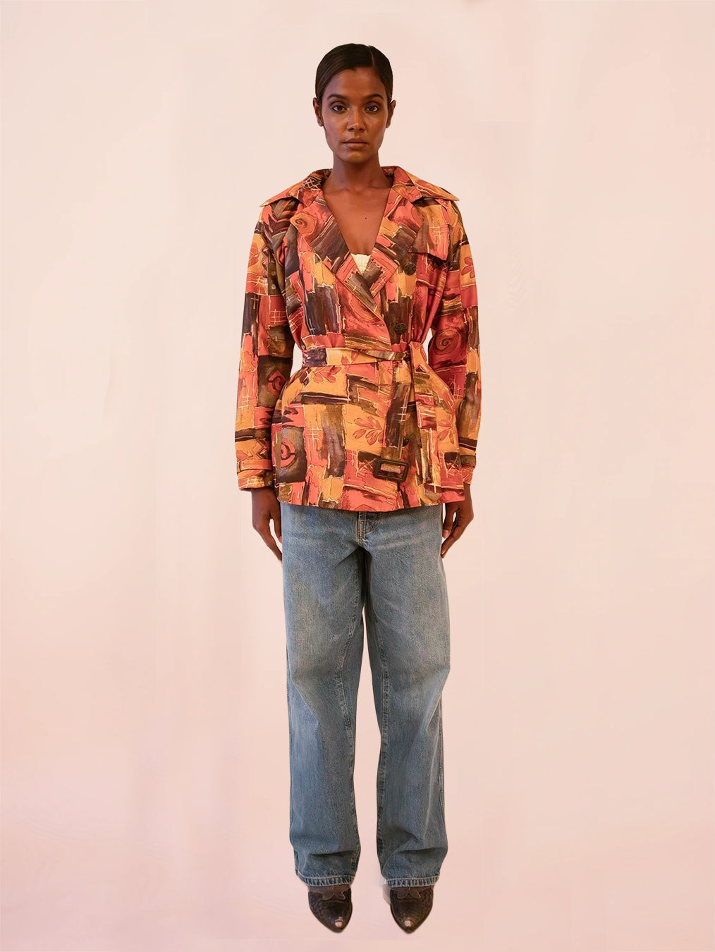 NIRA is our one-of-a-kind cropped abstract print silk trench coat, handcrafted by skilled artisans in-house using a one-of-a-kind vintage silk saree.