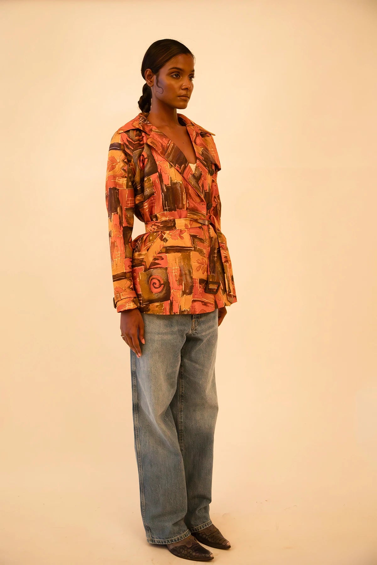 Cropped trench coat crafted from upcycled abstract print silk, featuring a relaxed fit and lightweight structure.