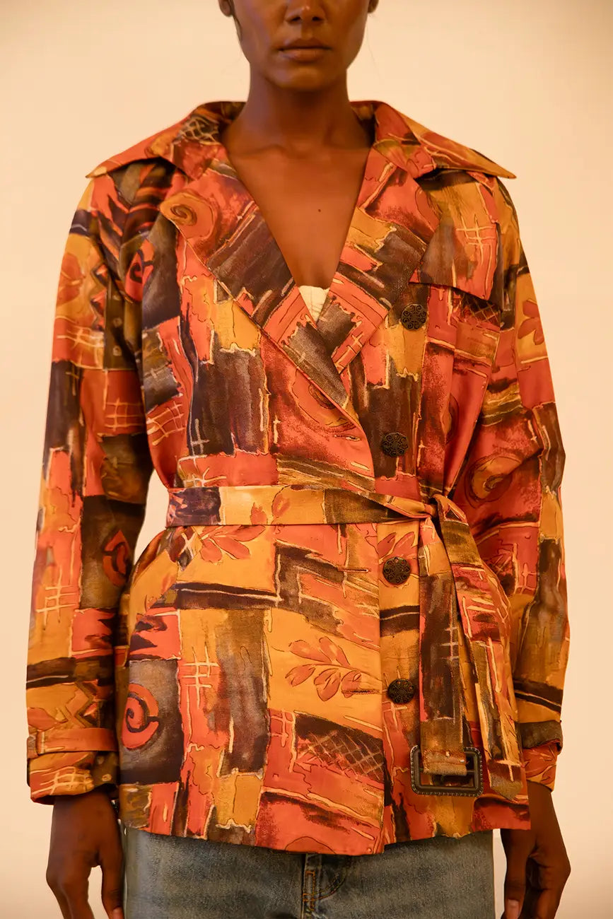 Cropped trench coat crafted from upcycled abstract print silk, featuring a relaxed fit and lightweight structure.